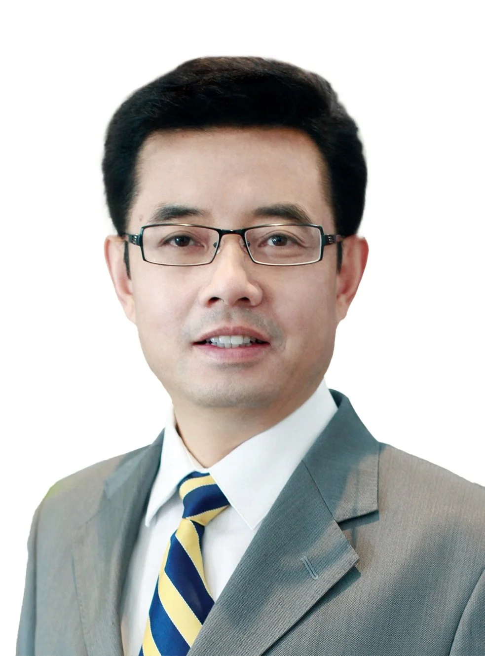 Portrait of a man wearing glasses, a gray suit, white shirt, and a blue and yellow striped tie, against a white background.