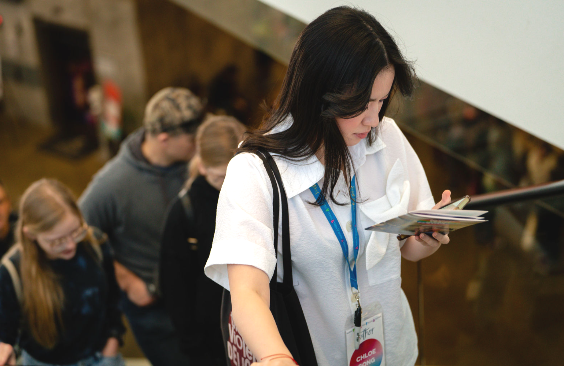 Professional photography of a delegate going to the next session at a conference in Dallas.