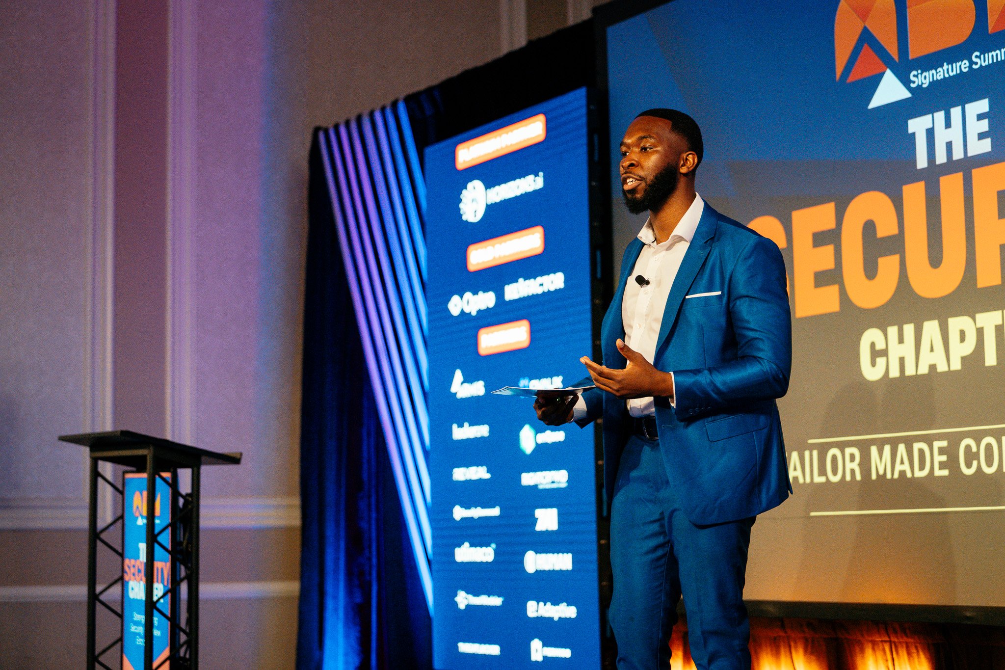 Photography of a conference speaker at a corporate executive summit the Adolphus Hotel in Dallas.