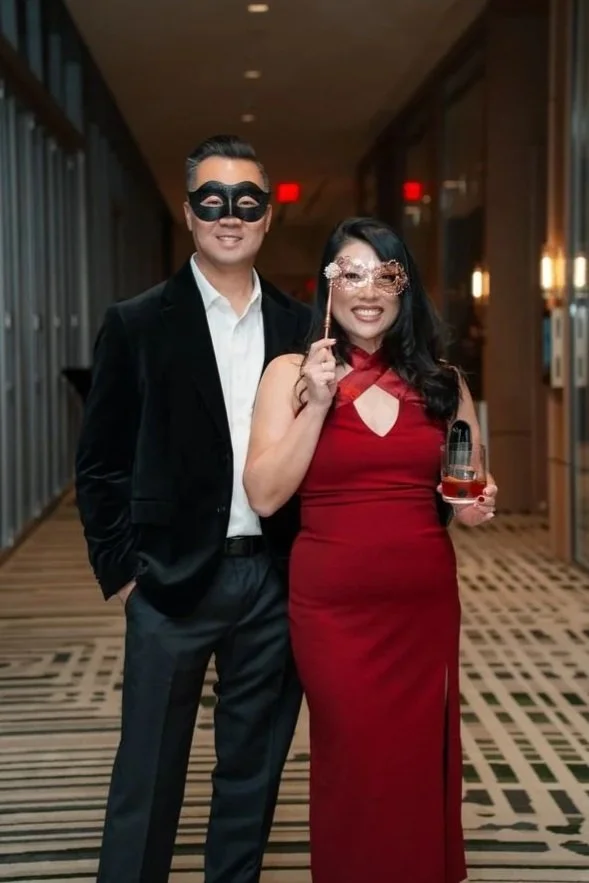 Photographer taking a photo of attendees dressed elegantly at a corporate gala in Dallas.