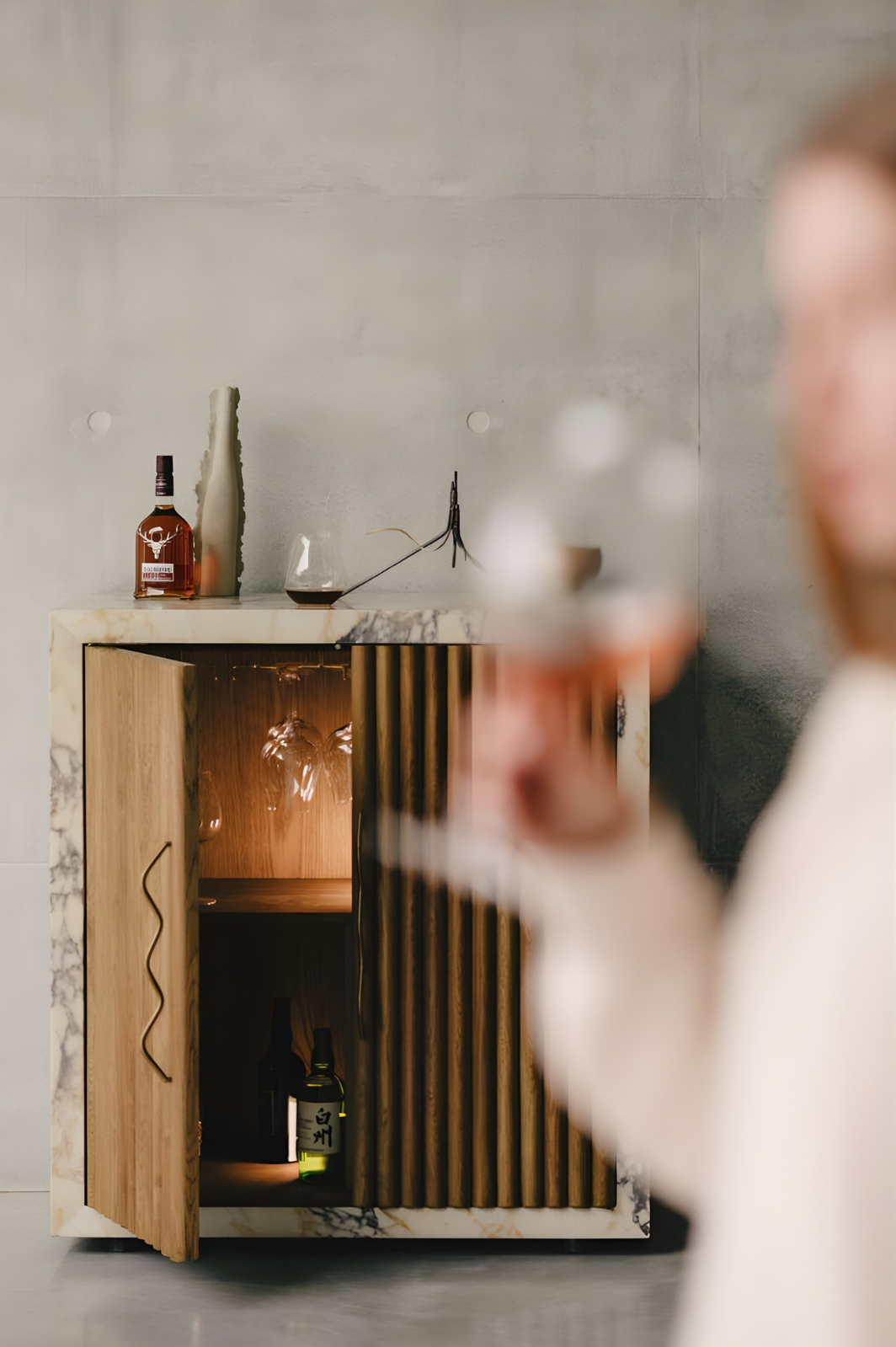 Home bar styling with drinks cabinet, glassware and relaxed entertaining mood.
