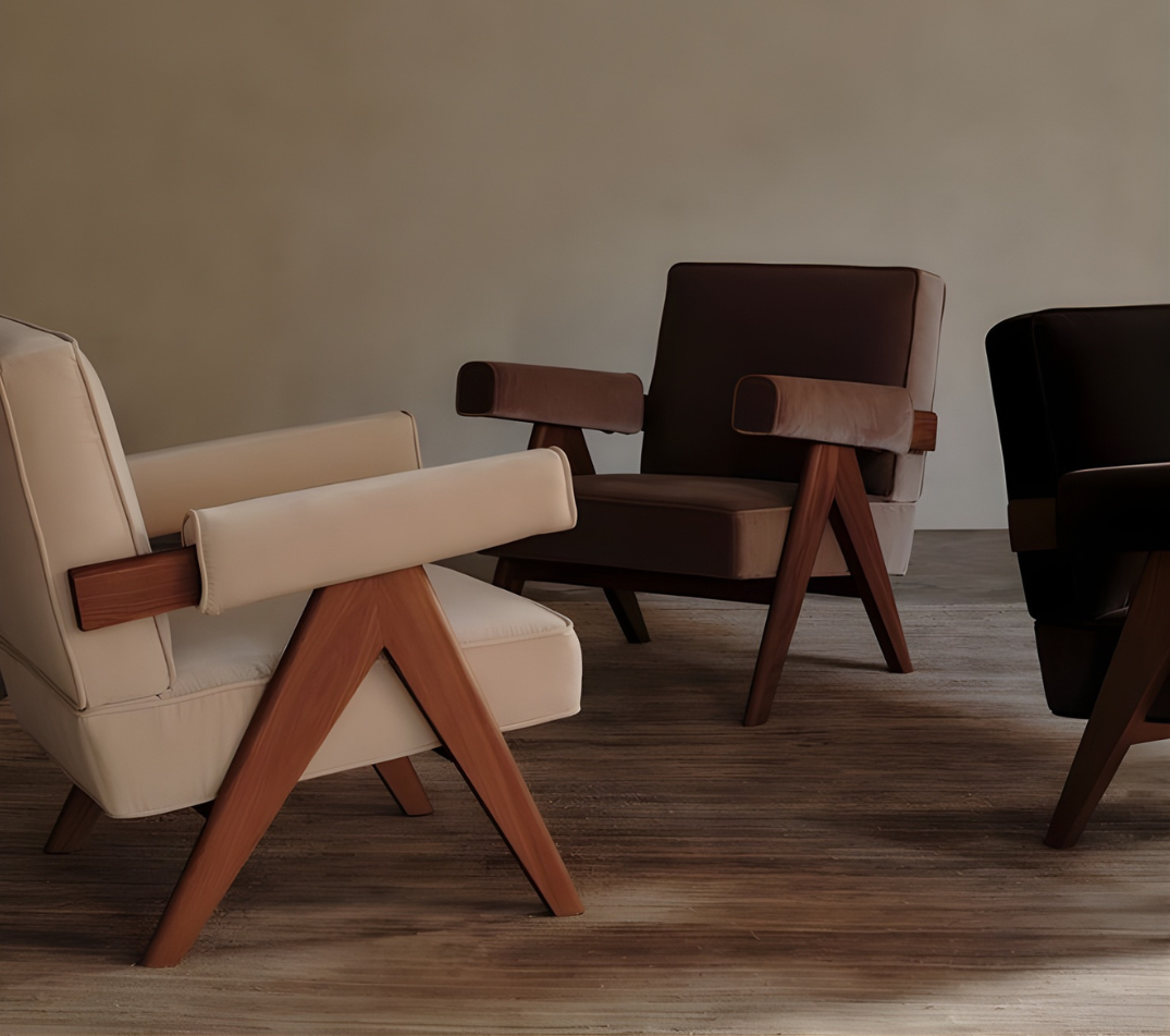 Designer MCM House accent chairs with timber frames styled in modern interior setting.