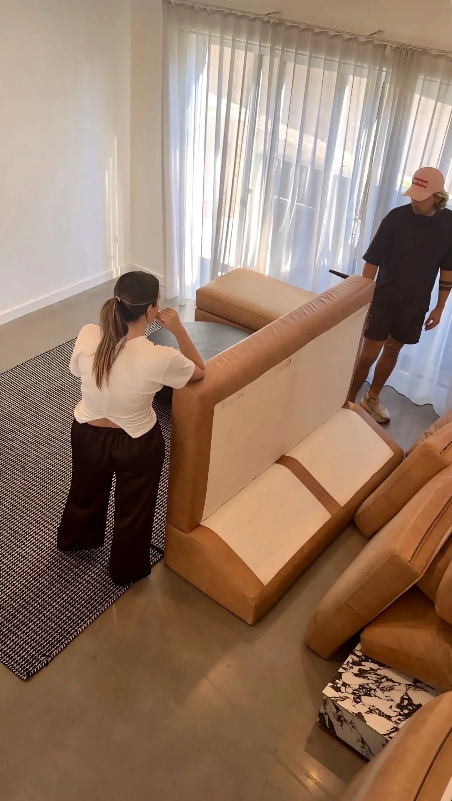Seconda team planning furniture placement during living room install.