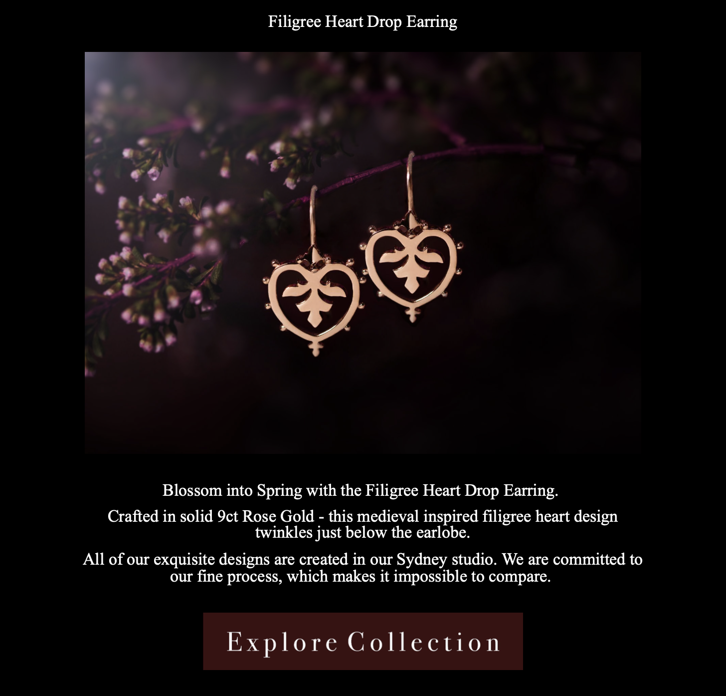 Close-up of gold Filigree Heart Drop Earrings hanging from a purple flower stem, with a dark background. The earrings feature medieval-inspired filigree heart design, crafted in solid 9-carat rose gold.