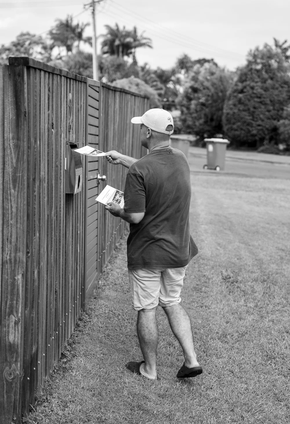Flyer being delivered into a residential letterbox in Noosa