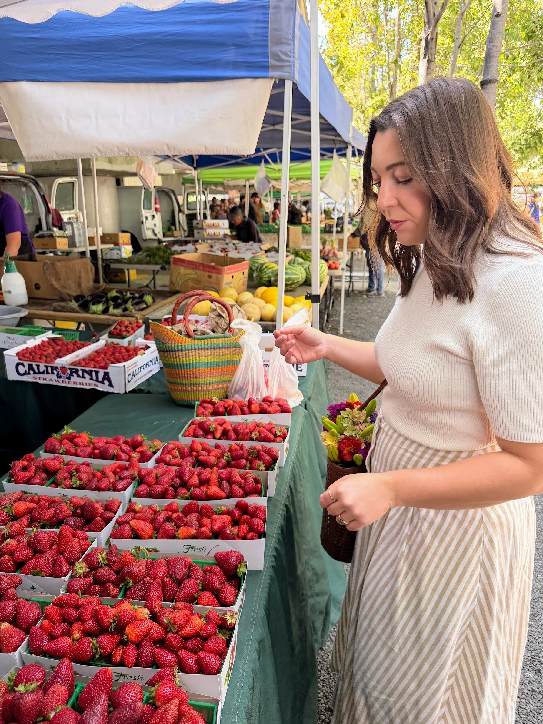 Dr. Ariana Feuvrier shopping for fresh produce at a farmers market