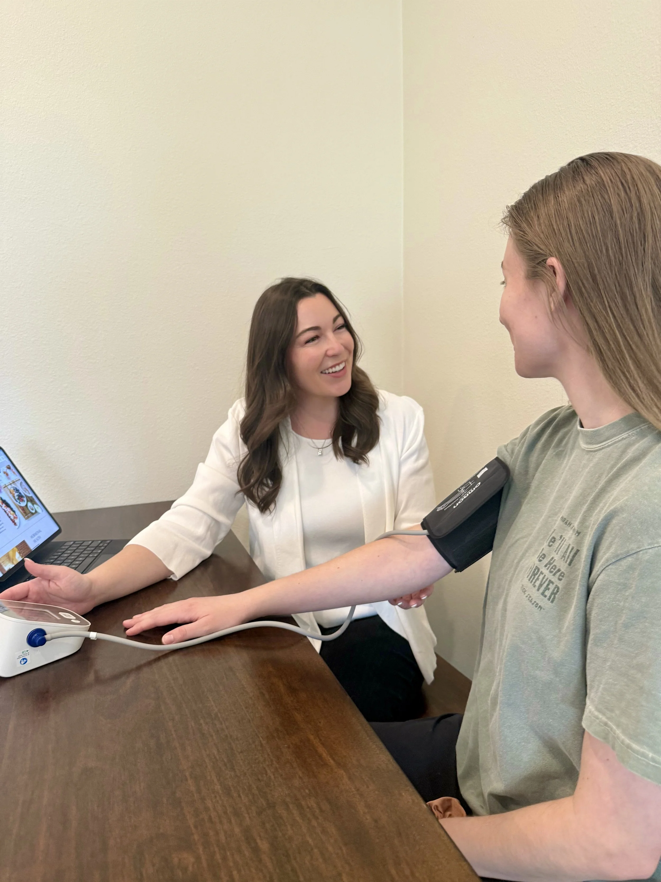 Dr. Ariana Feuvrier checking a patient's blood pressure