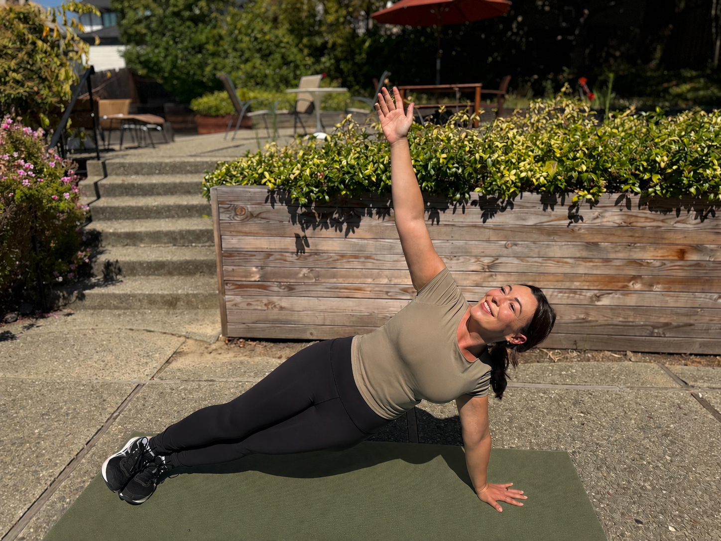 Dr. Ariana Feuvrier doing a side plank outdoors