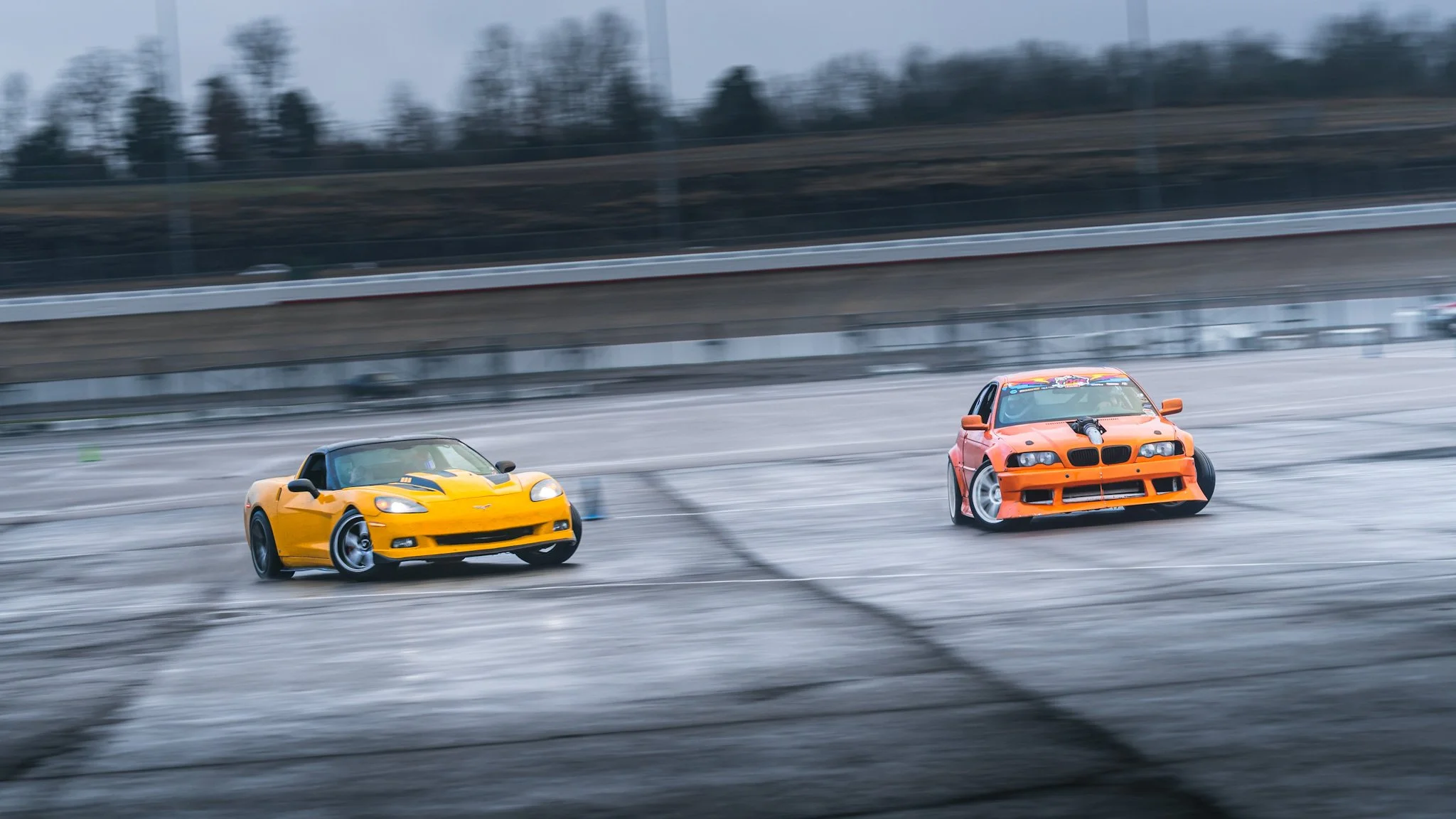 yellow c6 and orange bmw drifting in tandem