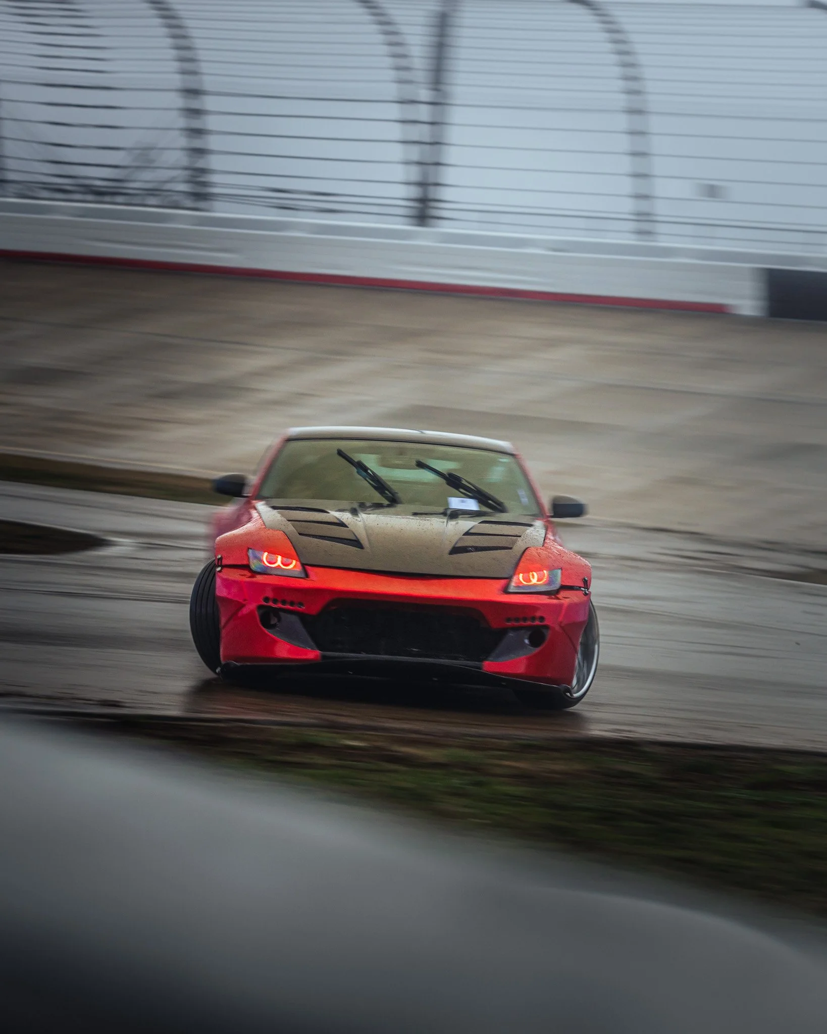 Red Nissan Z drifting  at stoopicold at Nashville Super Speedway