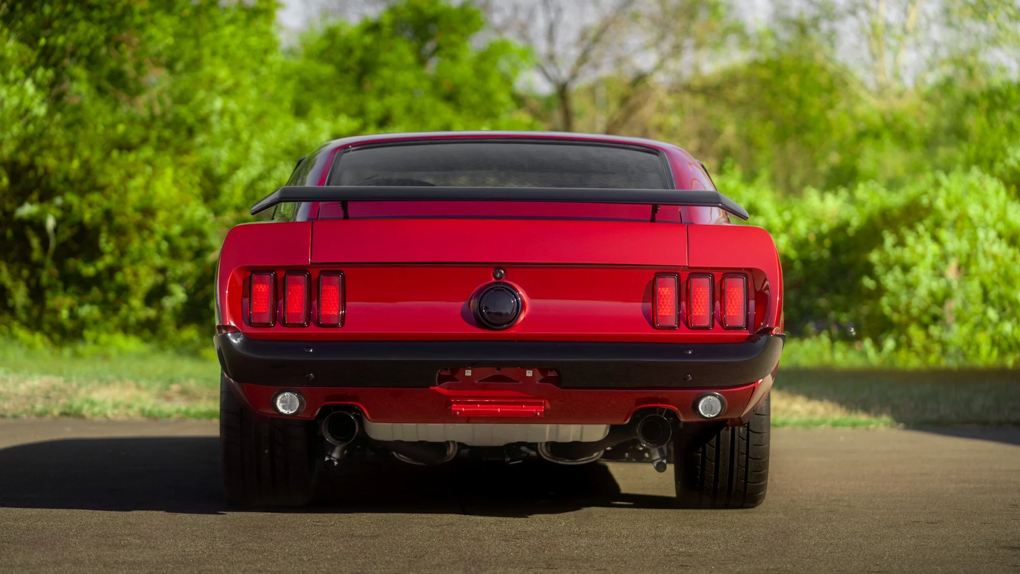 rear shot of red 1969 coyote swap mustang
