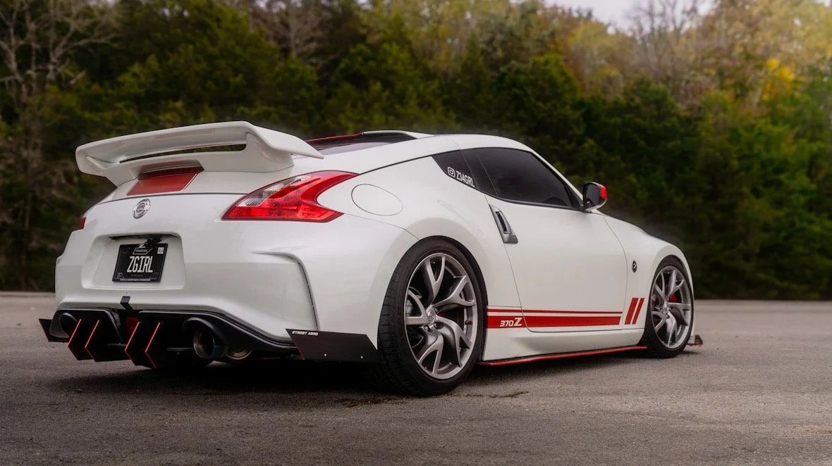 @z34grl 370z passenger quarter panel shot with trees in background