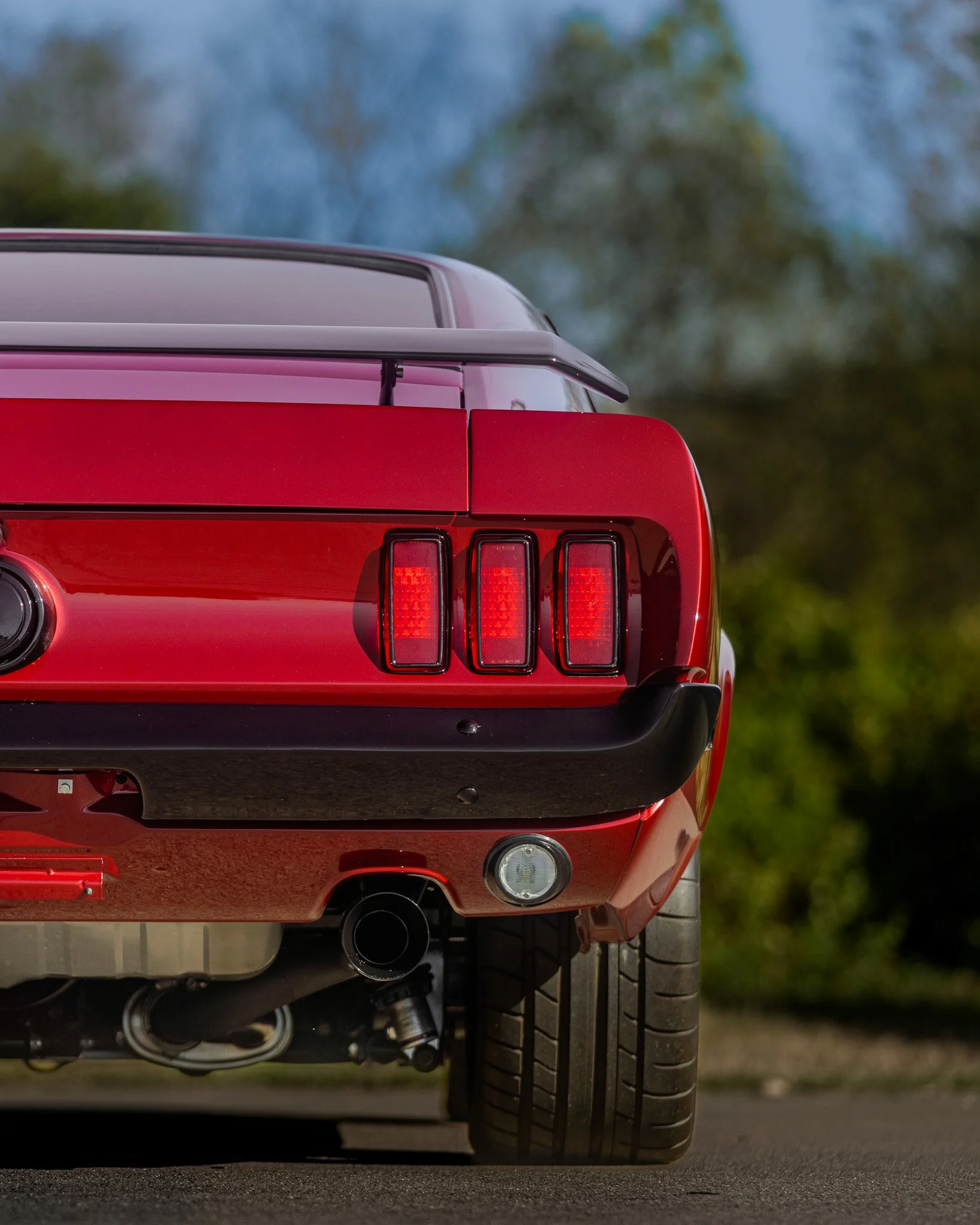 rear shot of red 1969 coyote swap mustang