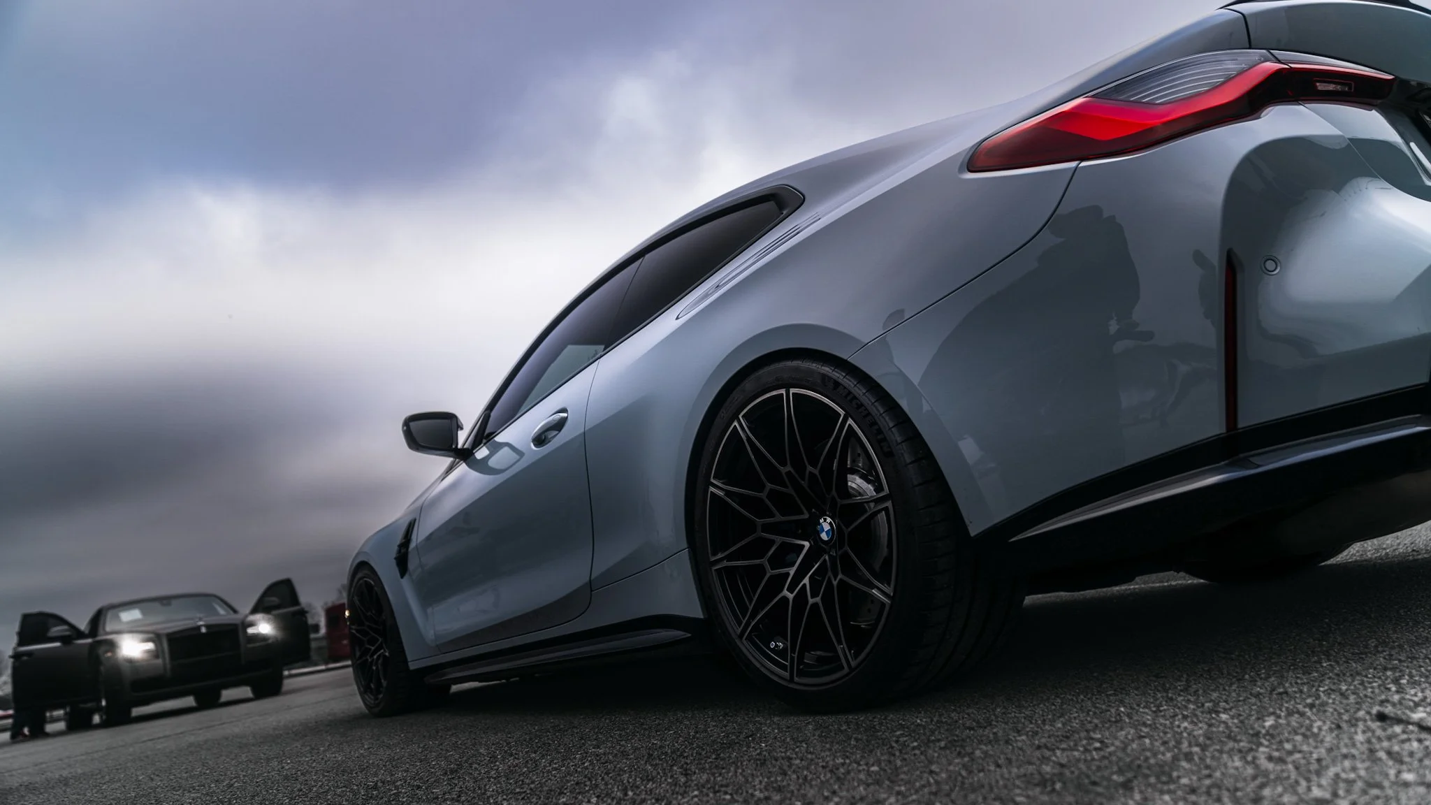 Ground driver side quarter panel shot of grey BMW M4