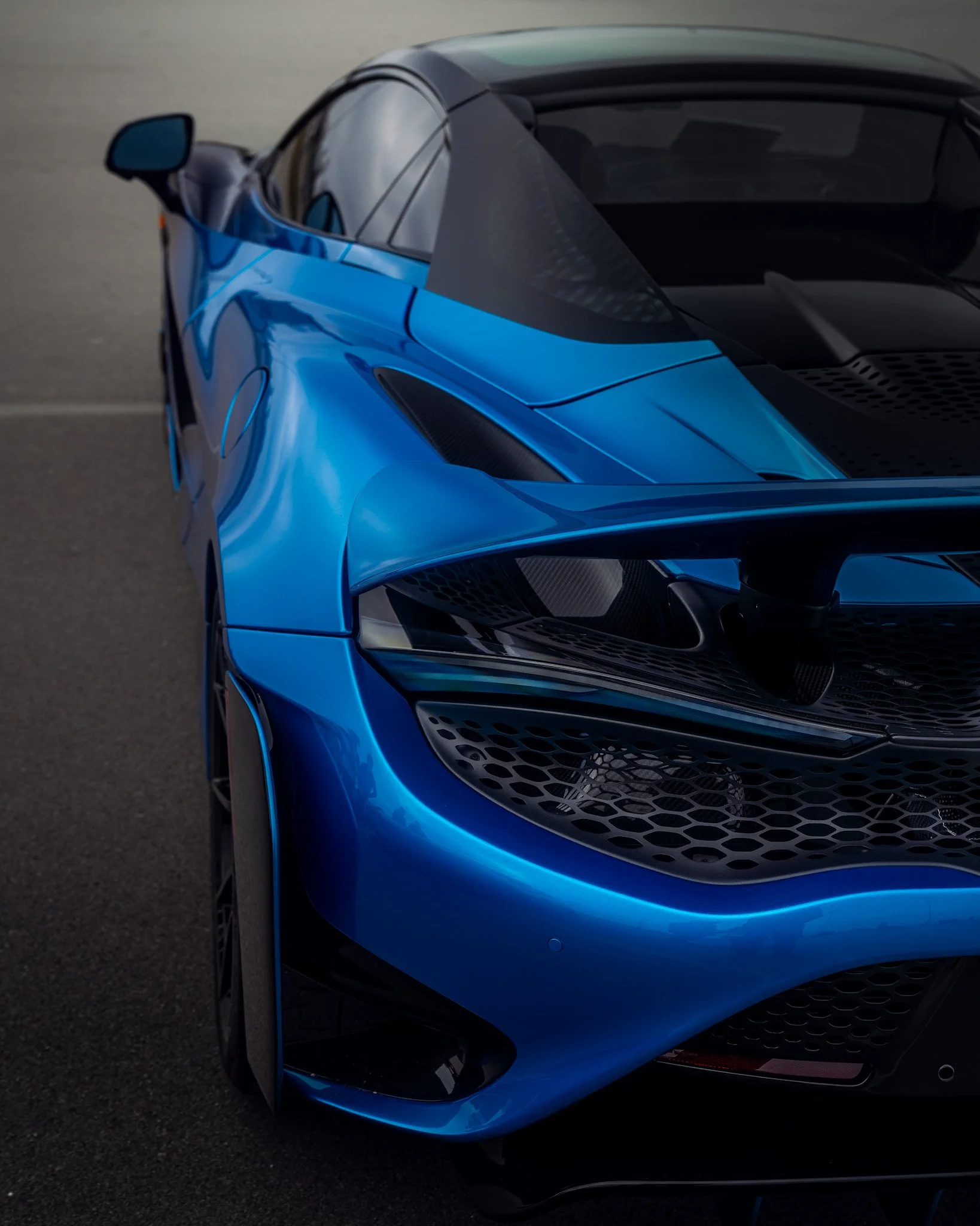 rear driver side shot of blue McLaren