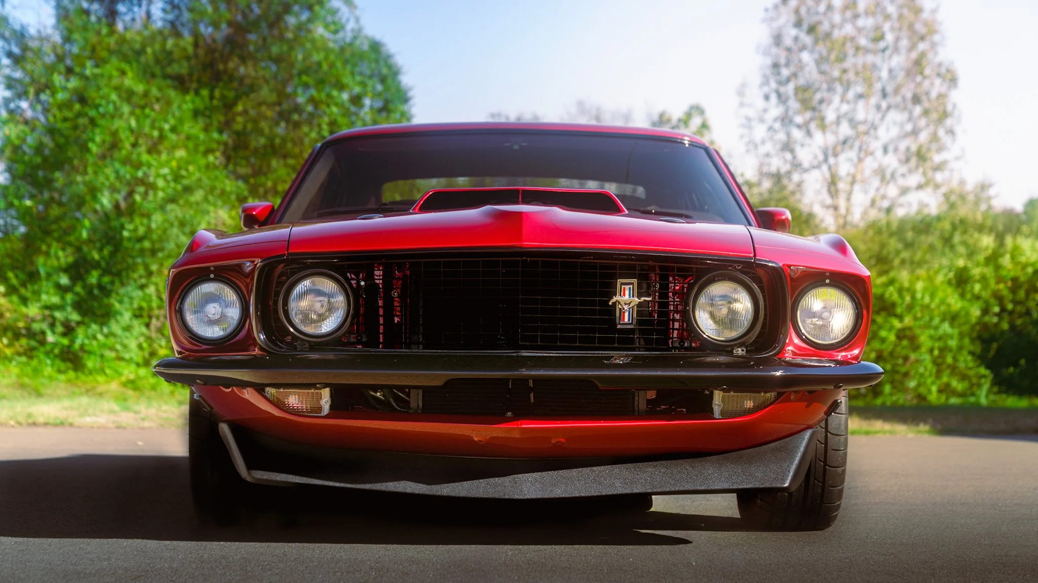 front shot of red 1969 coyote swap mustang