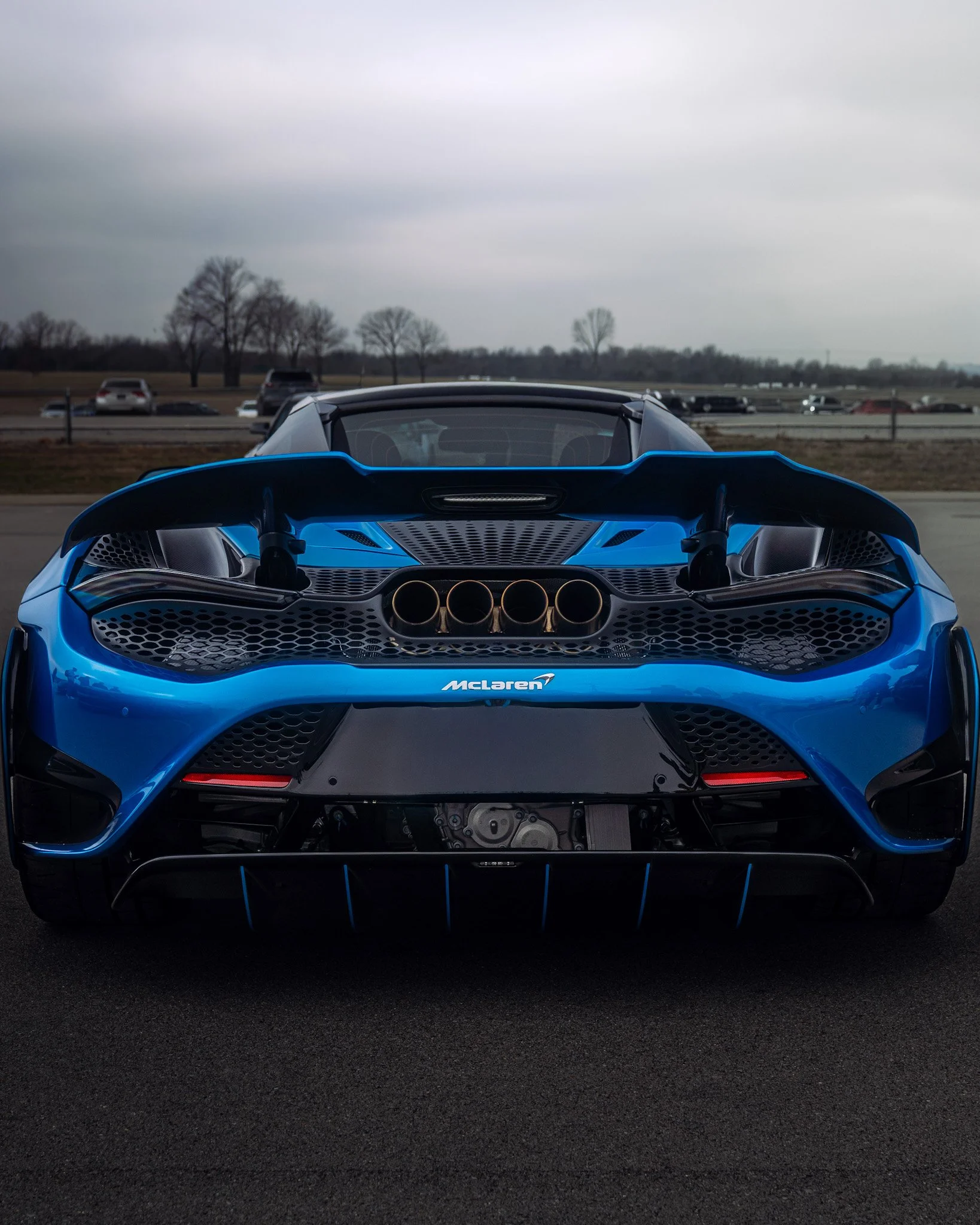 straight on rear shot of blue McLaren