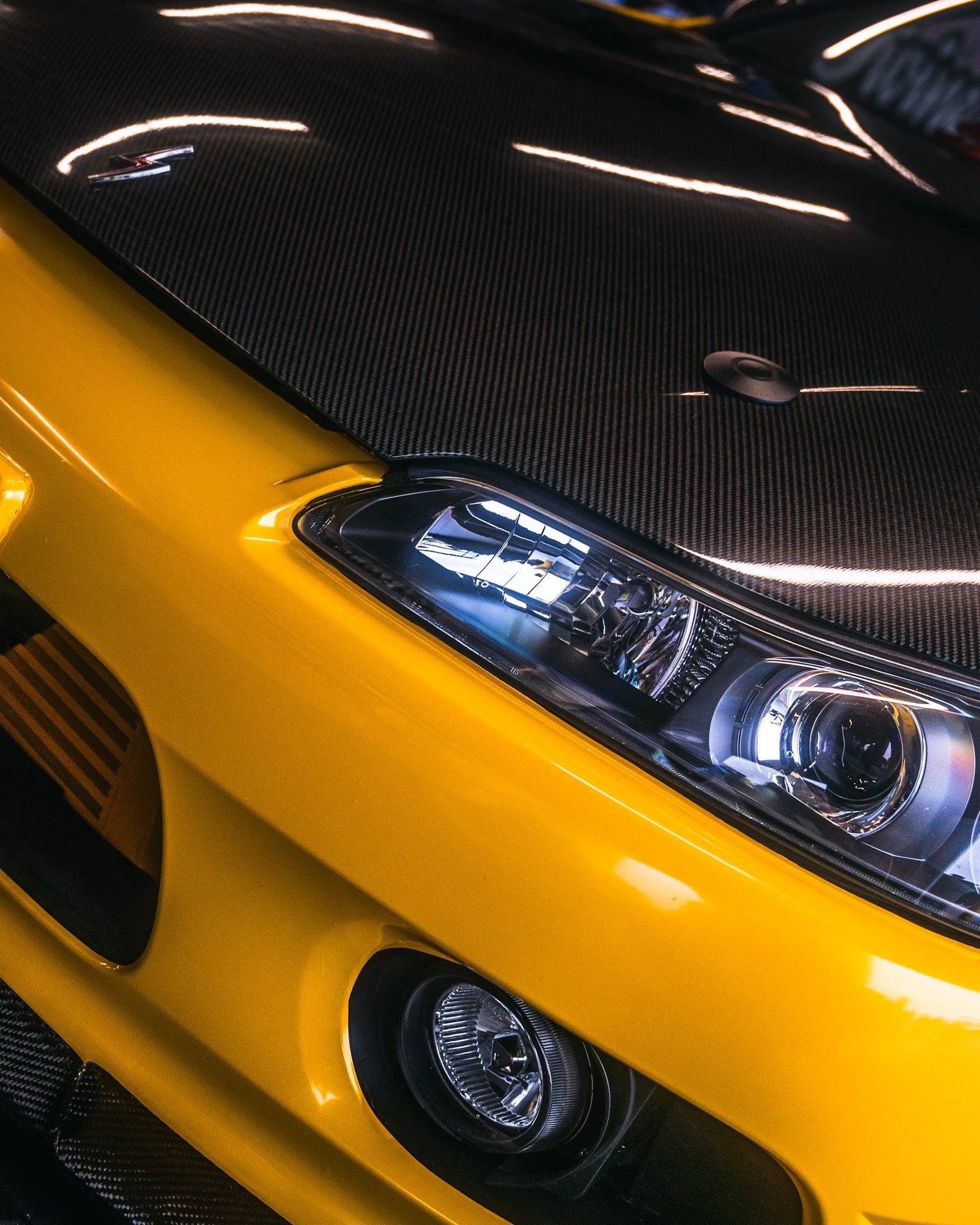 headlight shot of yellow Nissan S14.5 at stoopicold