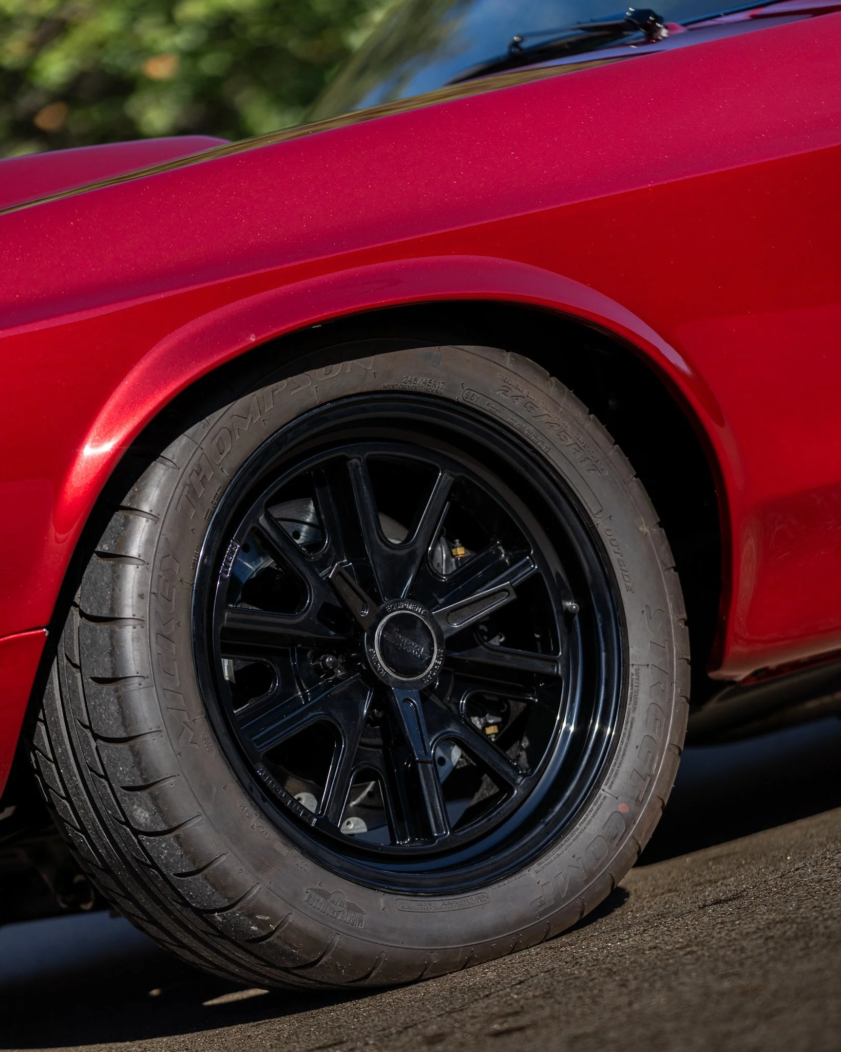 wheel shot of red 1969 coyote swap mustang