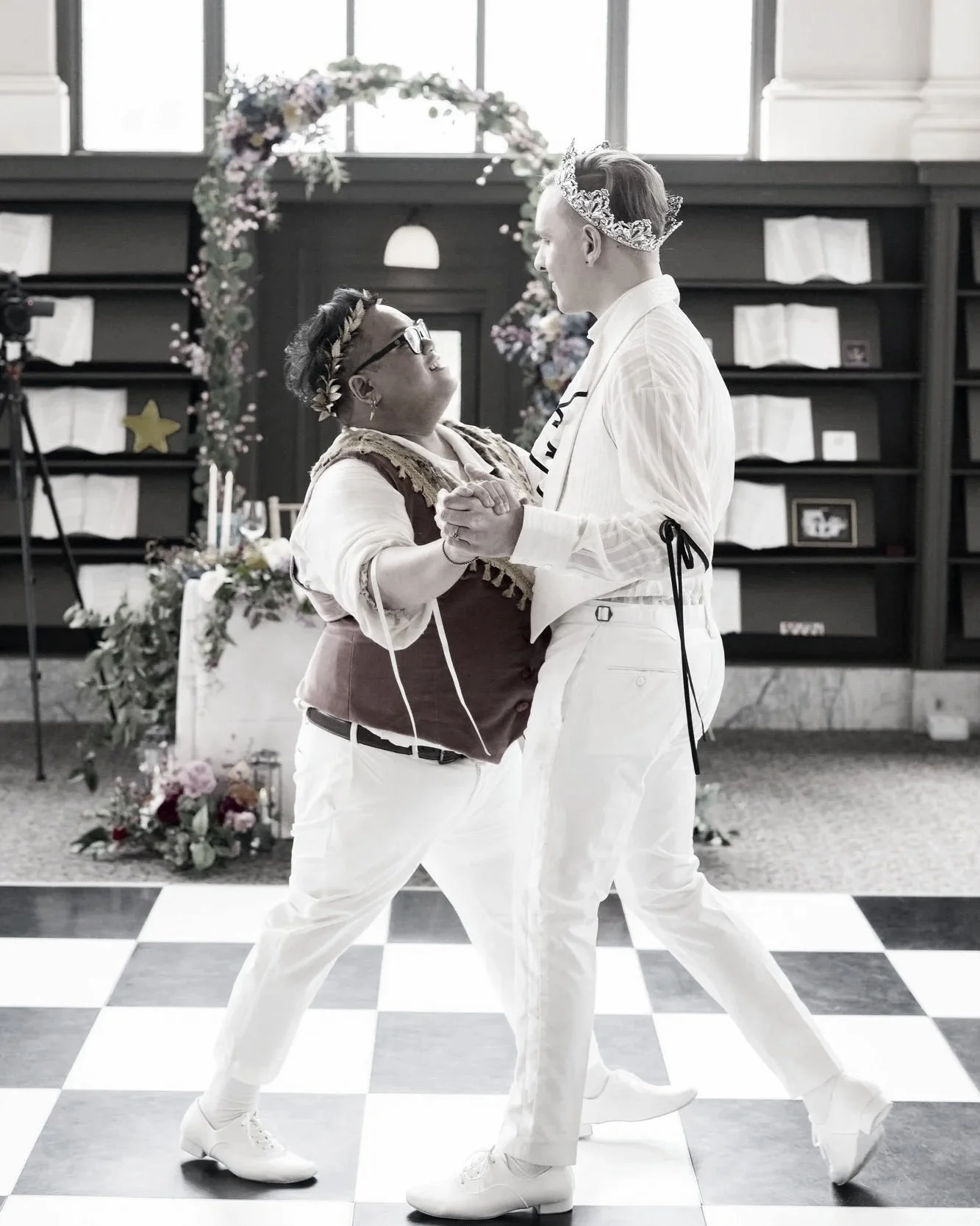 A couple dancing at their wedding, looking deeply into each other's eyes.