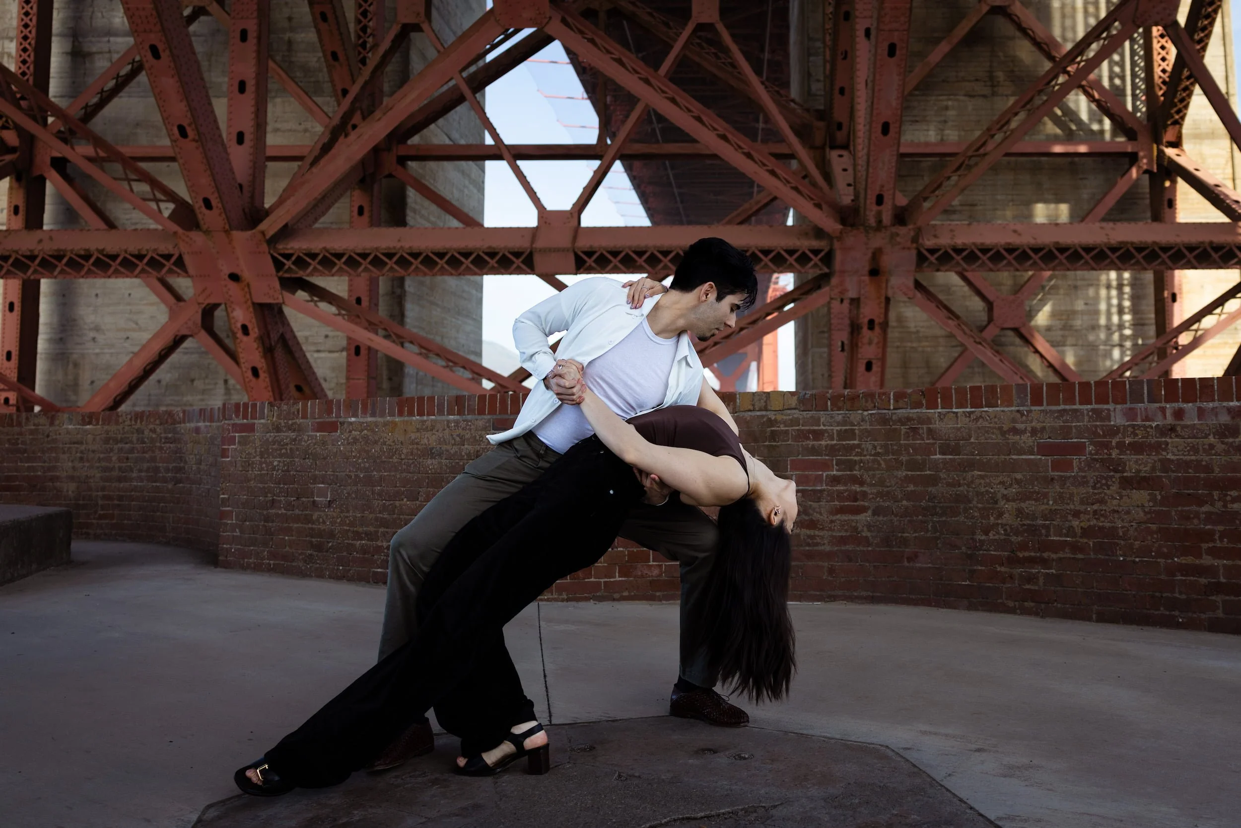 Richard Hornor, a wedding dance instructor based in San Francisco, dipping his dance partner below the base of the Golden Gate bridge.
