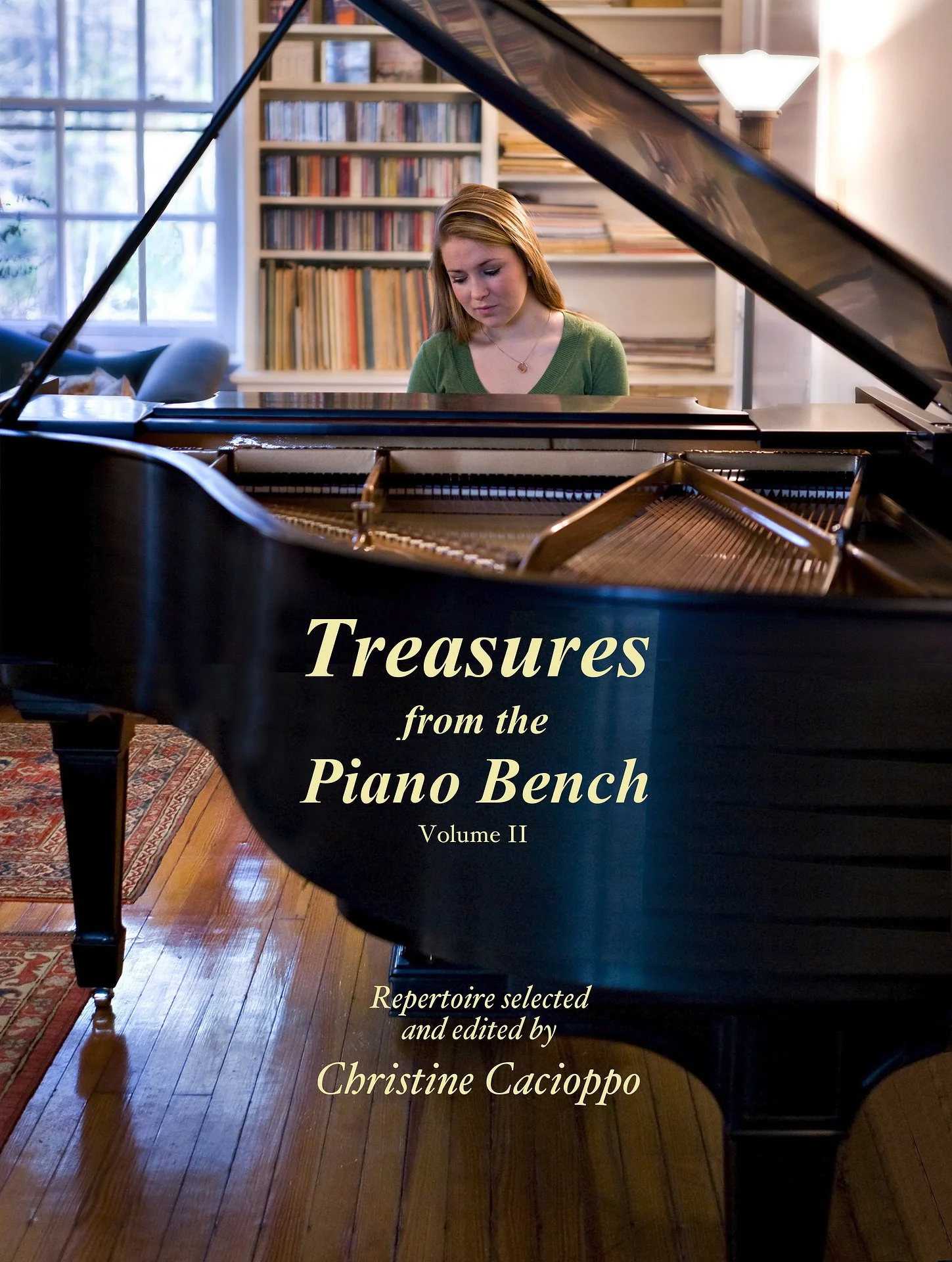 A young woman sitting at a grand piano in a cozy room with bookshelves and a window in the background, looking down.