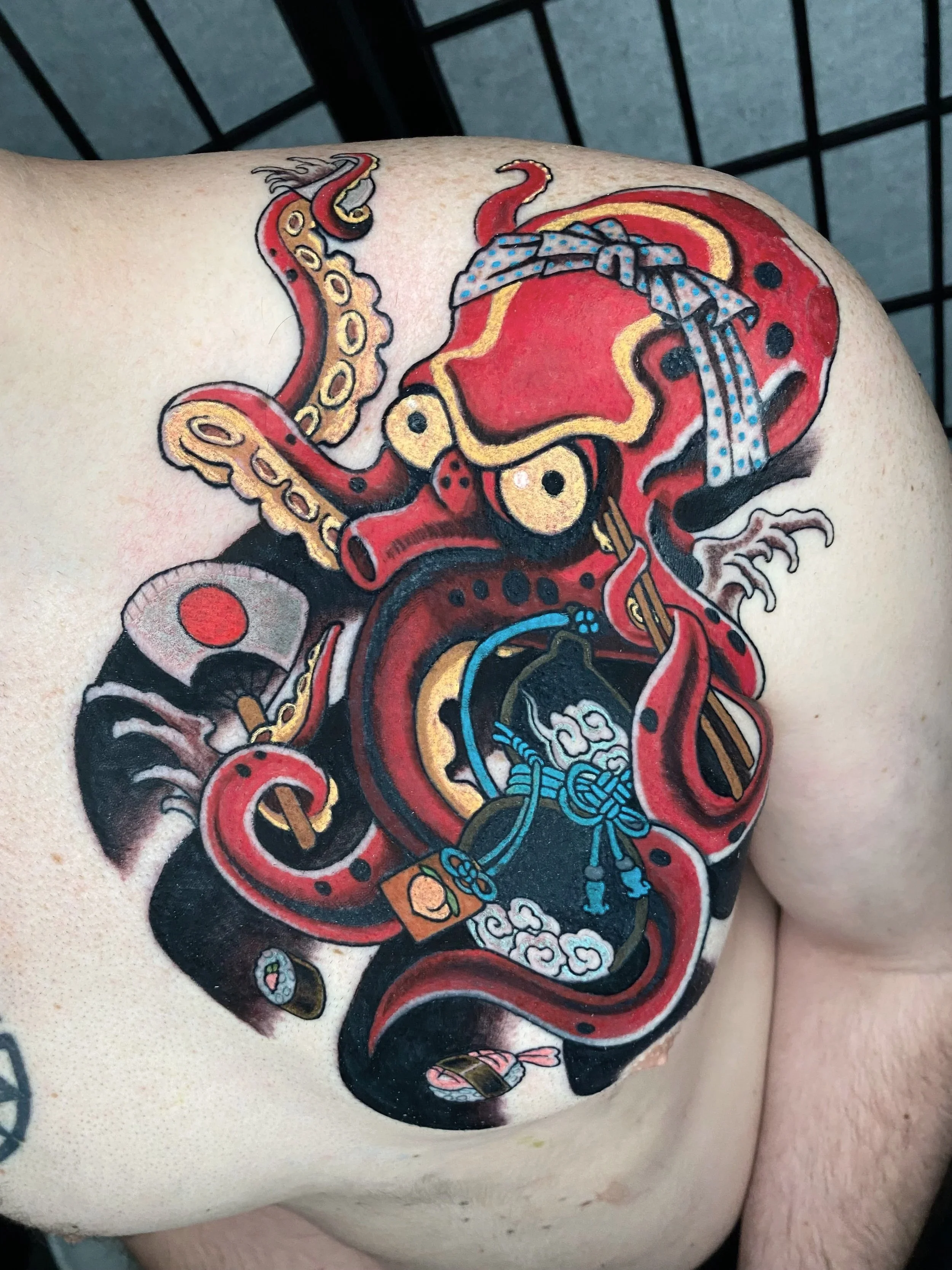 Japanese style red octopus sushi Chef tattoo