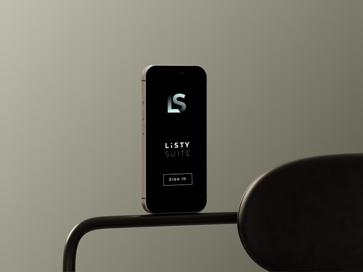 Smartphone displaying the Listy Suite app logo and sign-in button, placed on a black surface against a plain gray background.