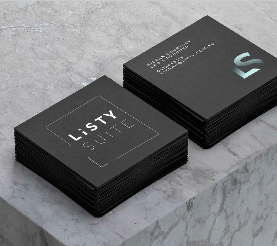 Stacks of black business cards on a marble surface, one with the text "LISTY LITE" and the other with contact information for Kieran Courtney, CEO and founder, including phone number and email address.