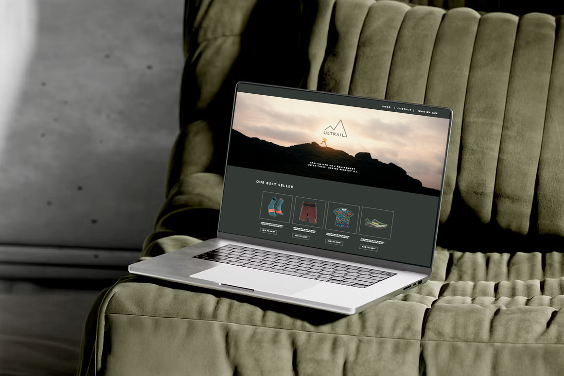 Open laptop on a beige couch displaying an outdoor gear website with hiking images and products.
