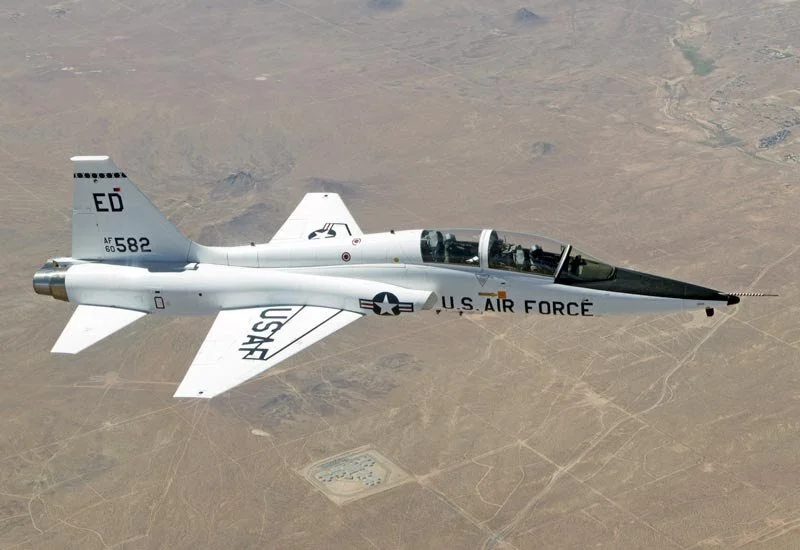 A U.S. Air Force jet, T-38 The White Rocket, flying over a desert landscape