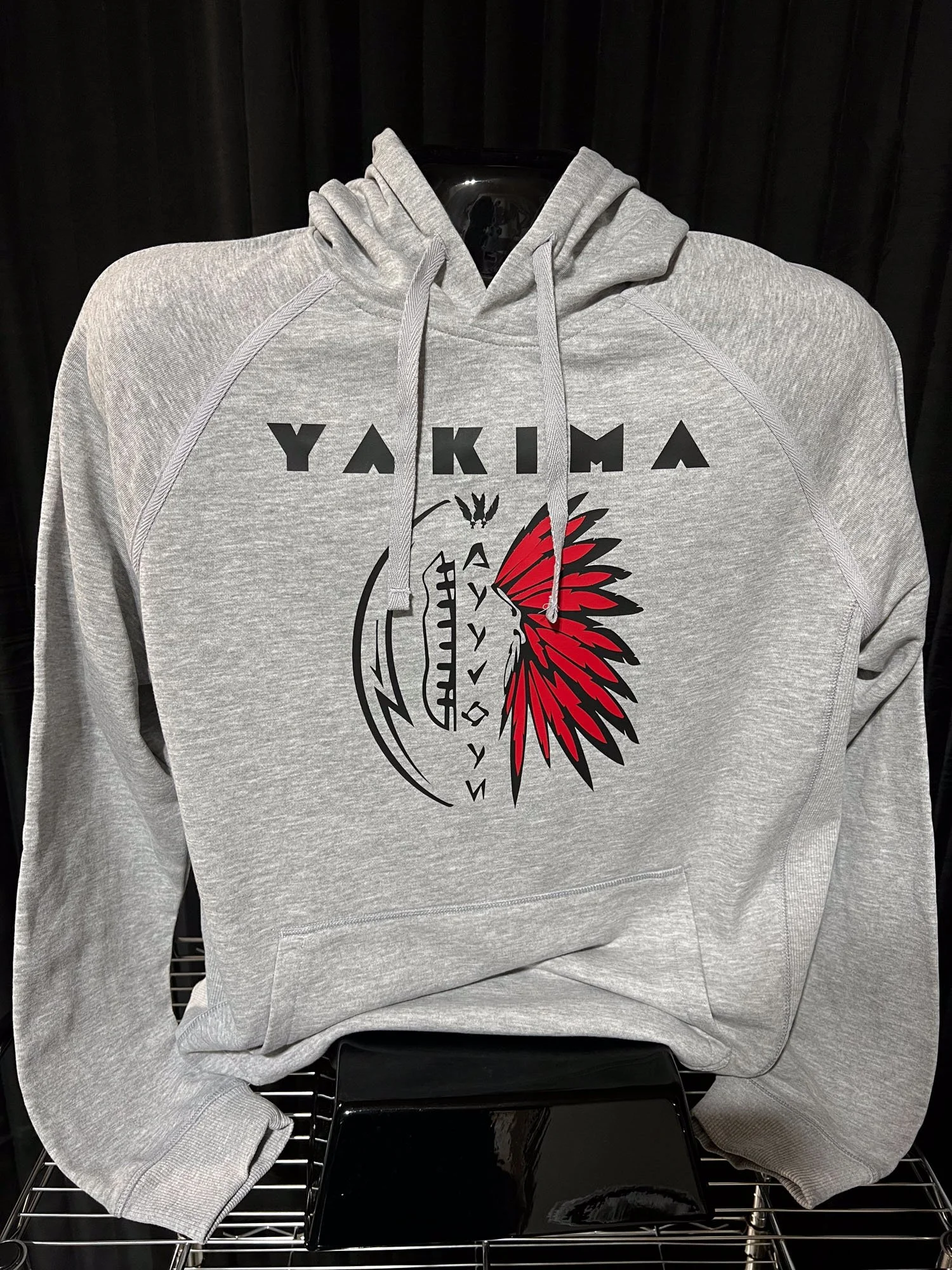 Gray hoodie with Yakima branding and a graphic of a Native American headdress in red and black on the front.
