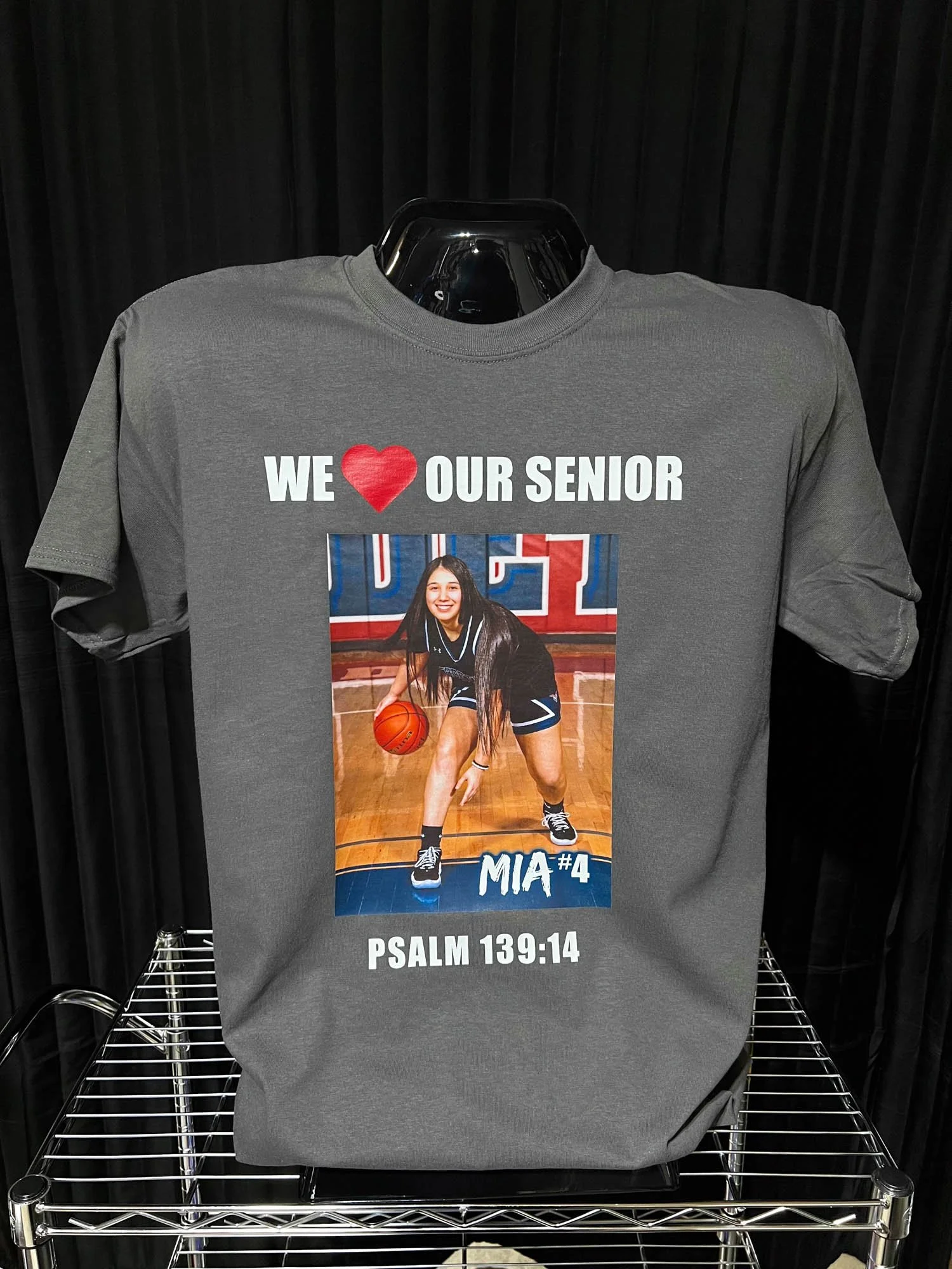 Gray T-shirt with a photo of a girls basketball player and the text 'We love our senior MIA #4 Psalm 139:14'