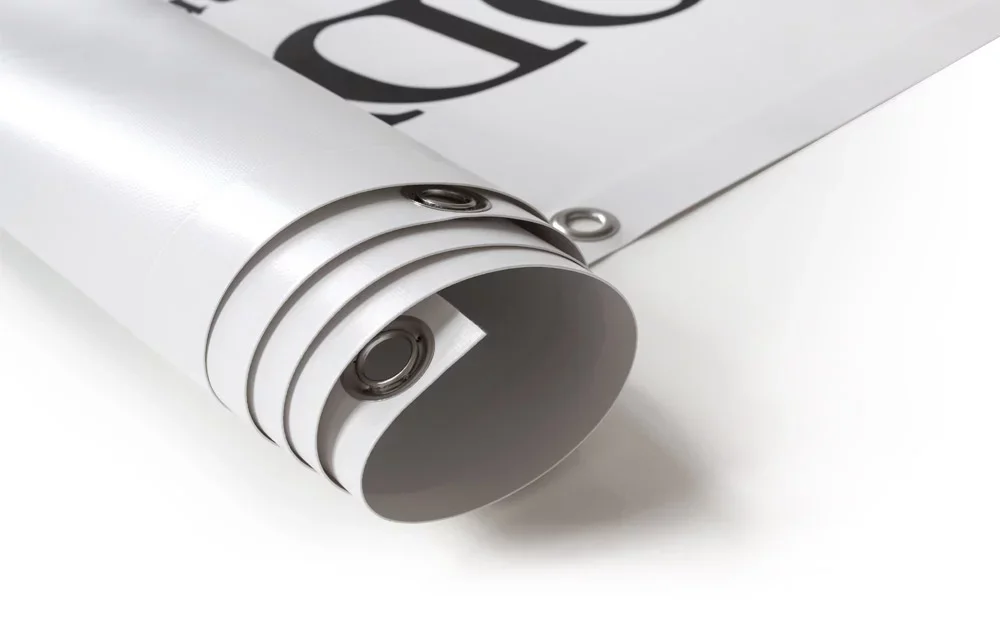 Close-up of a rolled-up poster or print with a metallic tube used for transporting or storing it.