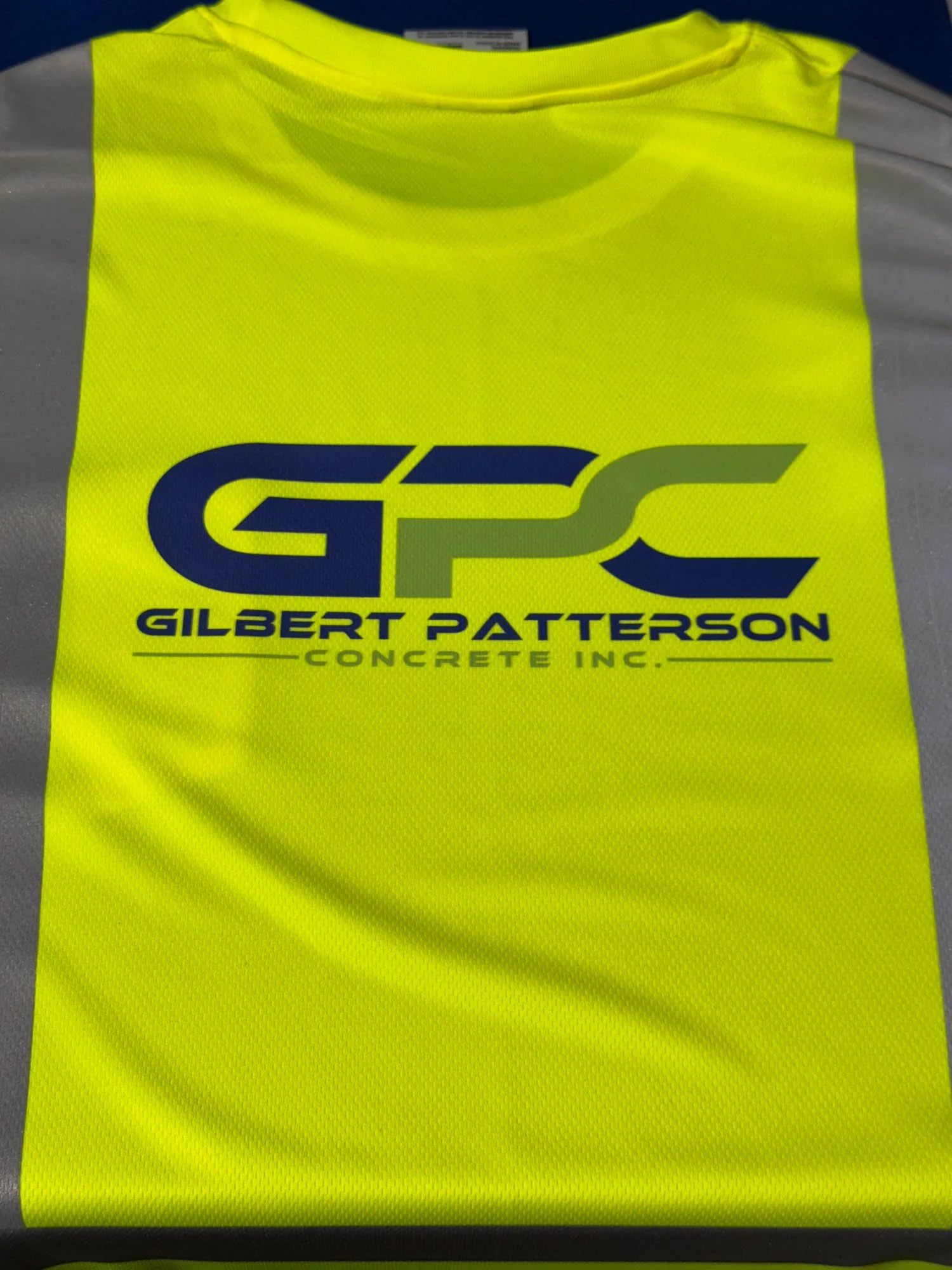 Bright yellow safety vest with a logo and text for Gilbert Patterson Concrete Inc.