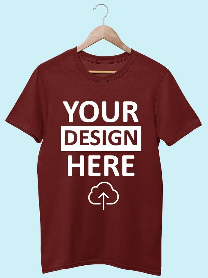 Red T-shirt hanging on a wooden hanger with 'Your Design Here' text and an upload icon printed on it.