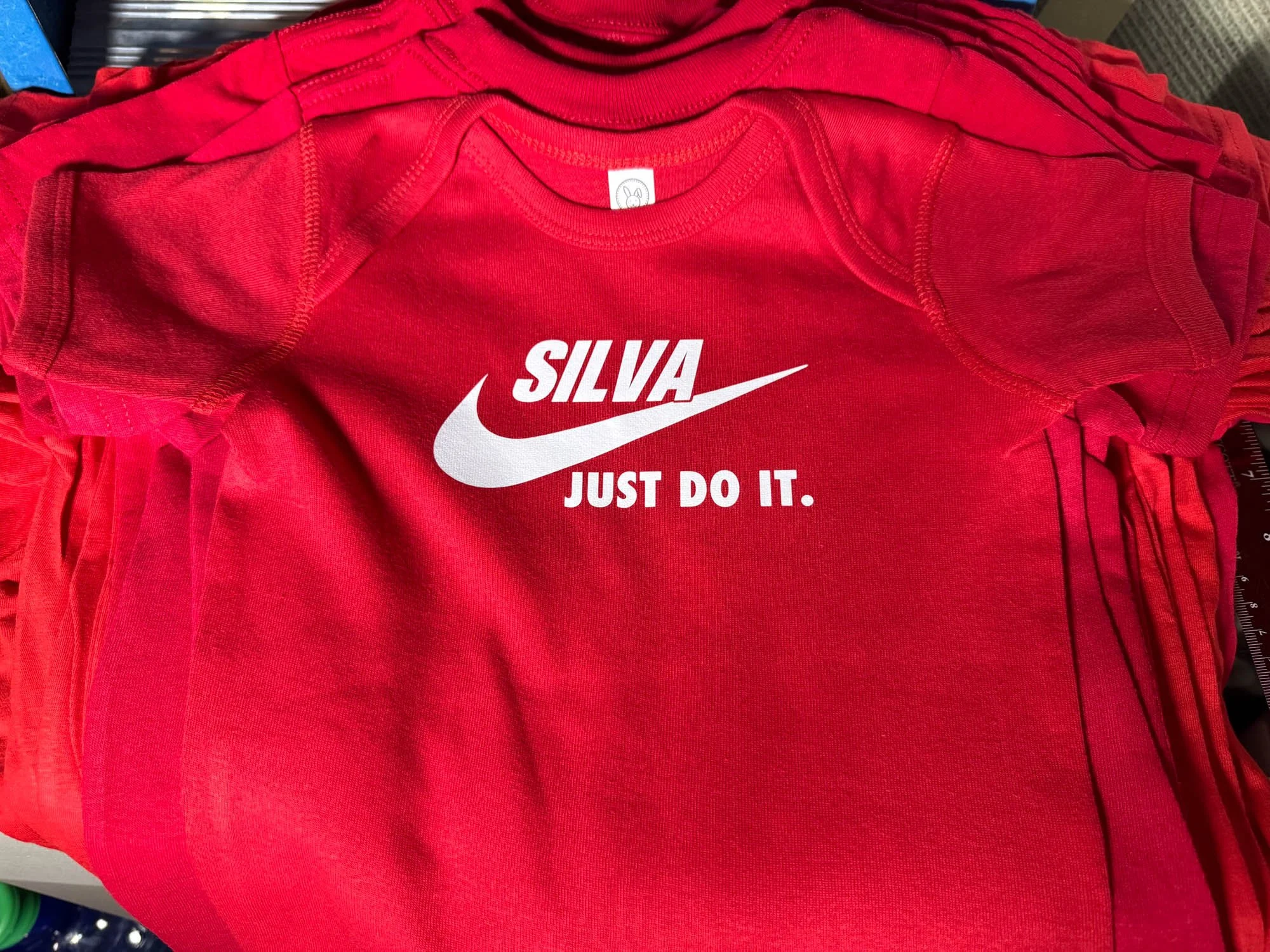 A red Nike T-shirt with the name 'Silva' and the slogan 'Just Do It.' printed in white.
