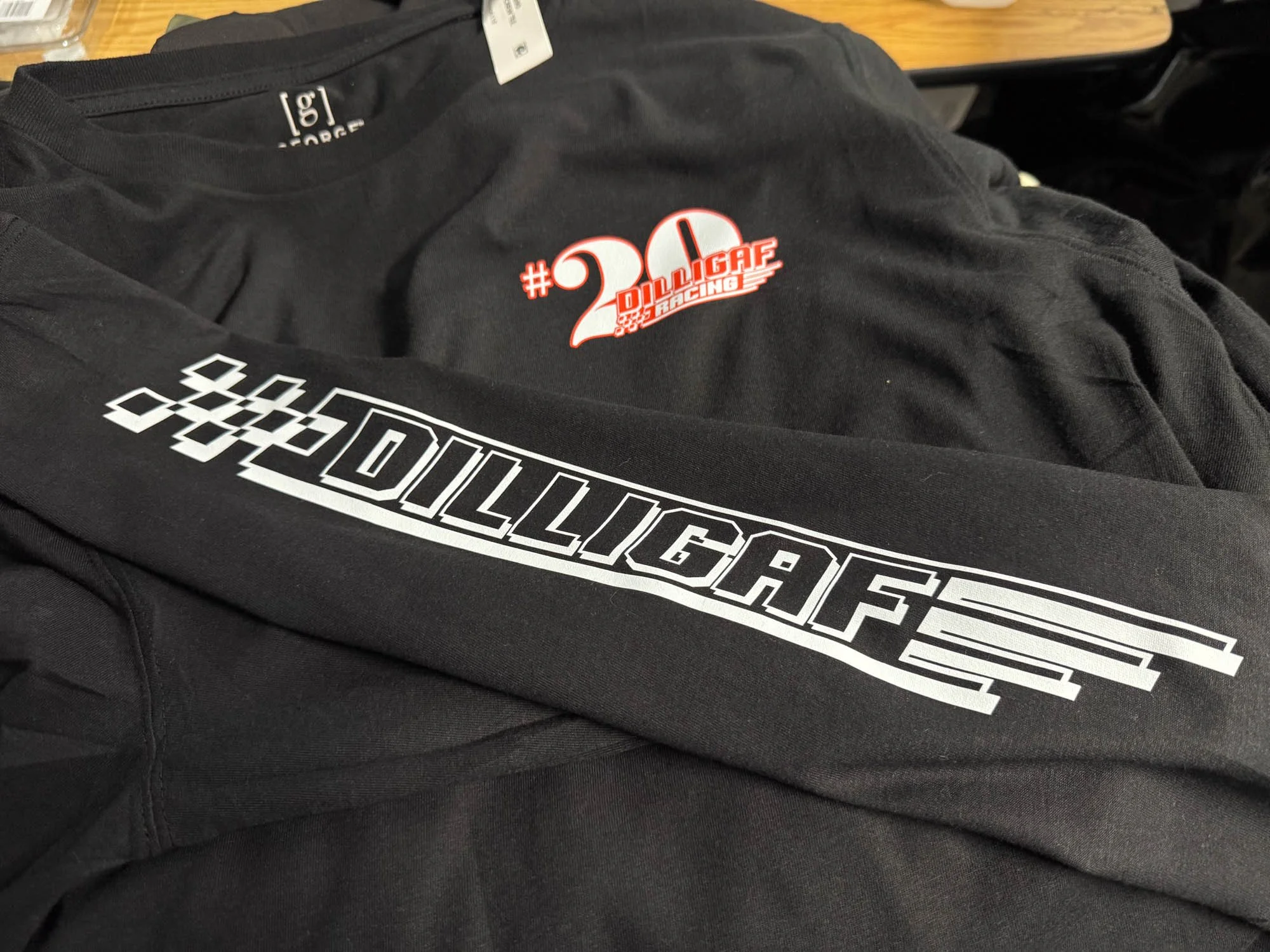 Black T-shirt and long sleeve or sweatshirt with DILLIGAF logo and hashtag #20 DILLIGAF RACING on them.