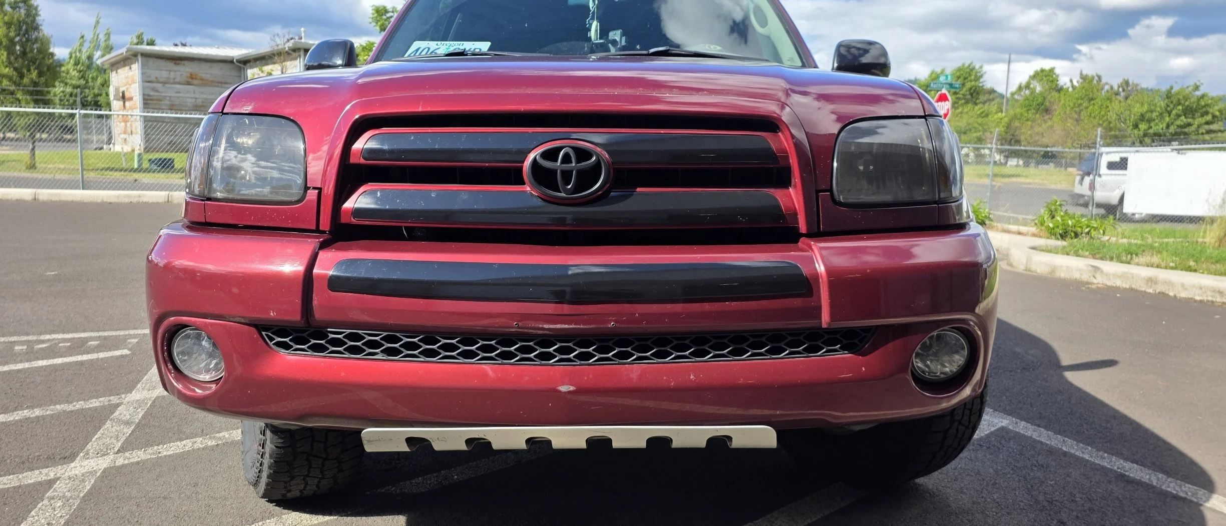 Front view of a red Toyota SUV parked in a parking lot.
