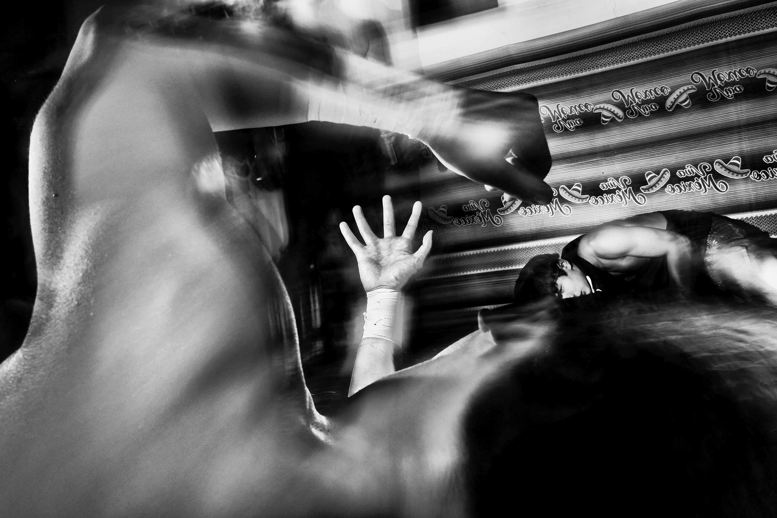 Black and white abstract photo of wrestlers.