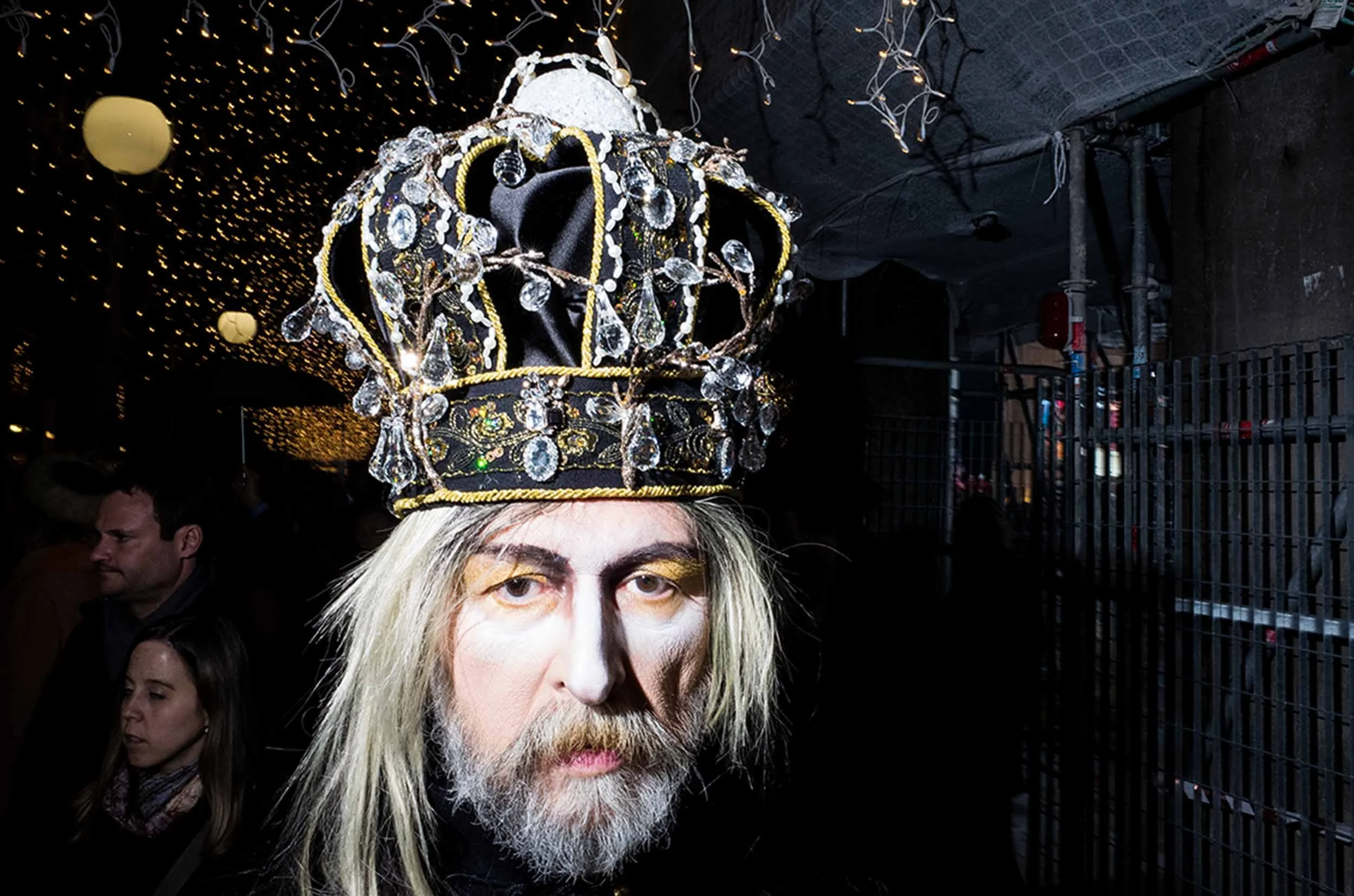 Photograph of an elderly gentleman wearing an elaborate crown.