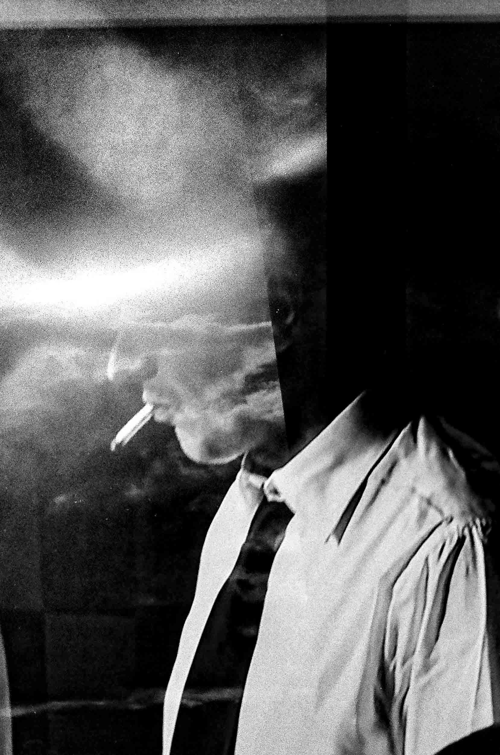 Black and white artistic photograph of a gentleman smoking.