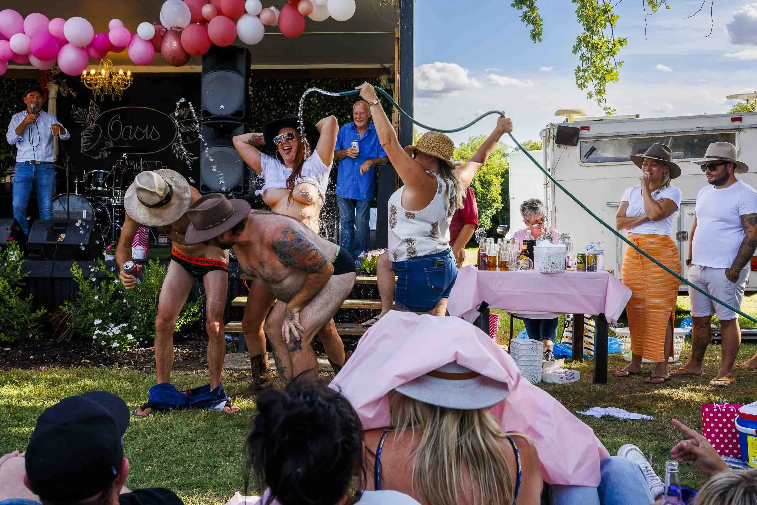 Two gentlemen and one lady participate in Australia’s last wet t-shirt competition.