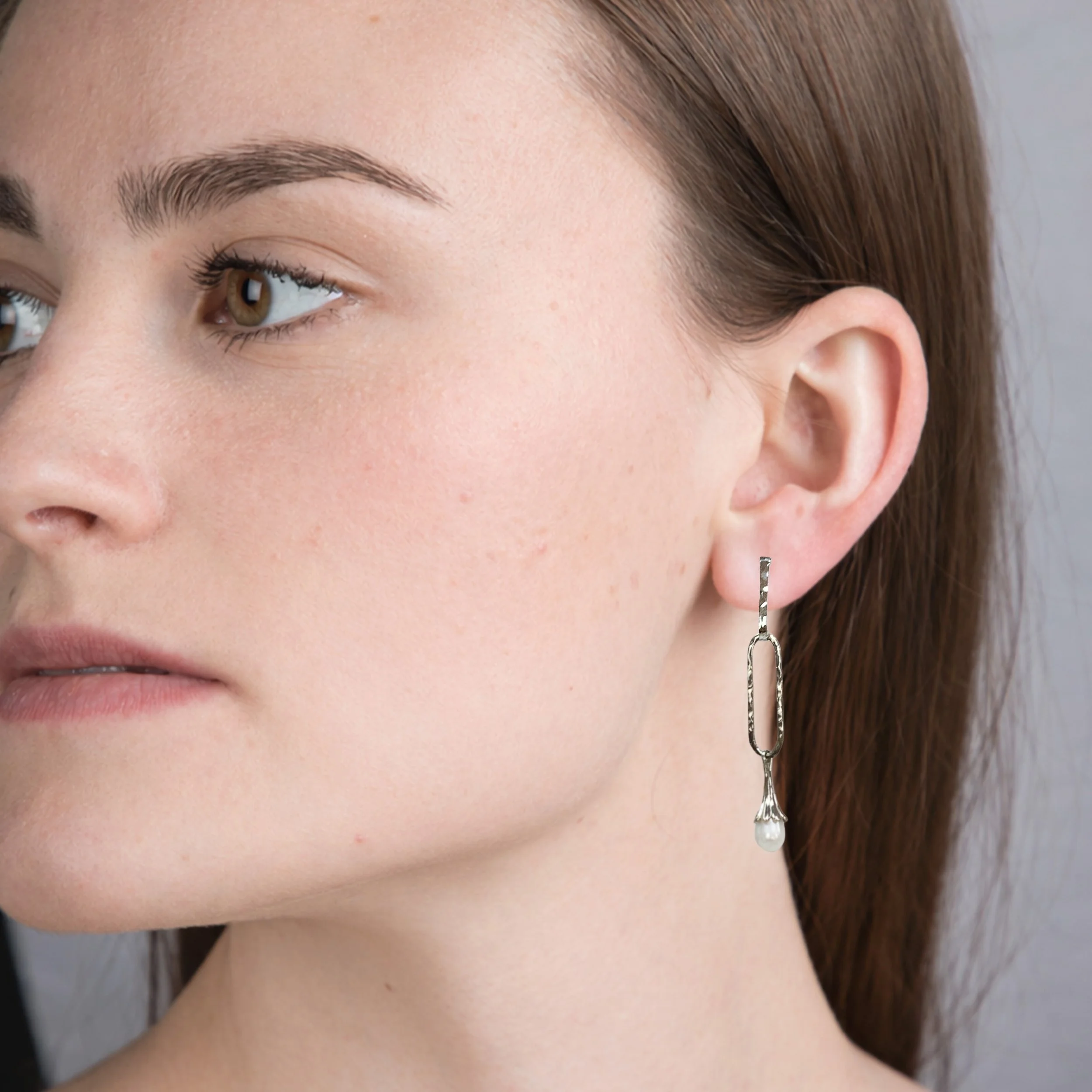 Elegant elongated hammered artisan created paperclip earrings with pearl drops