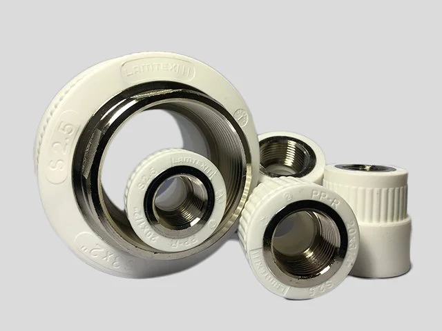 Several ceramic and metal plumbing pipe fittings and bushings with threading.