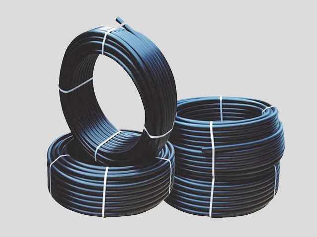 Three rolls of black plastic tubing stacked on a plain gray background.