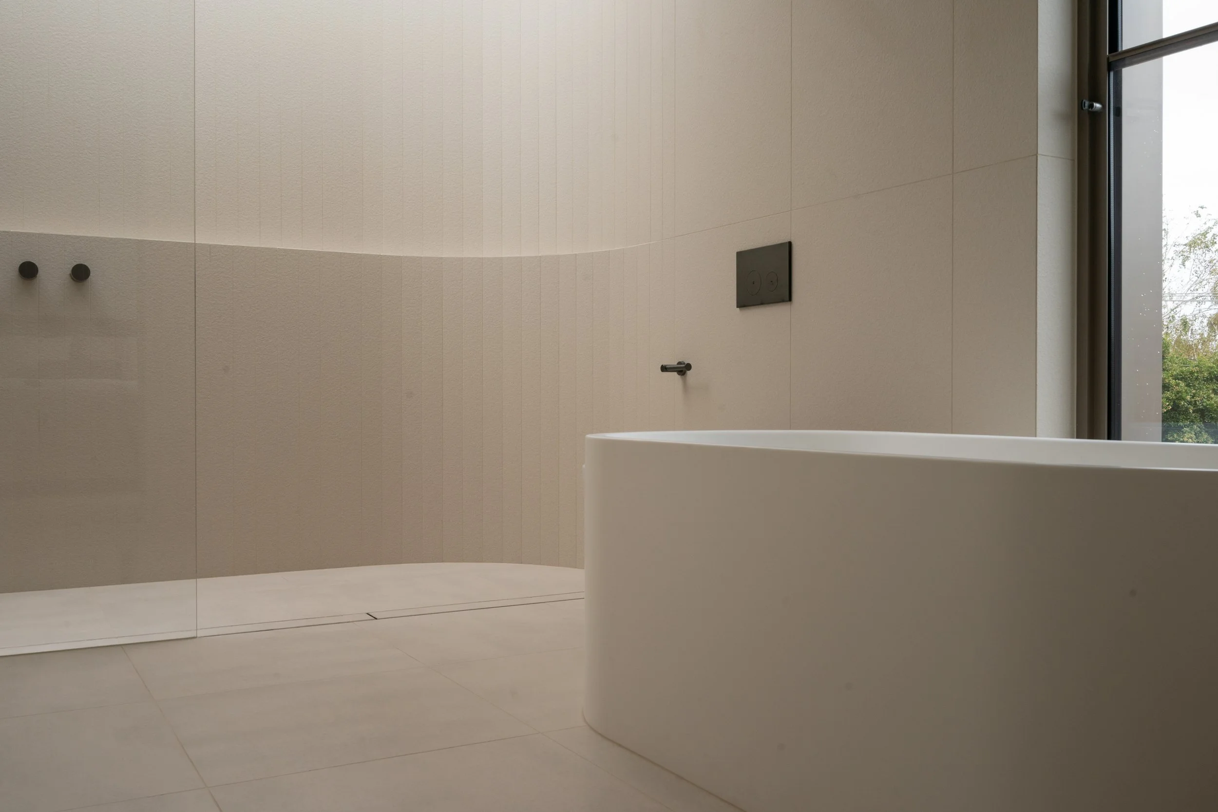 Large format tiled shower wall with gunmetal tapware, Melbourne bathroom