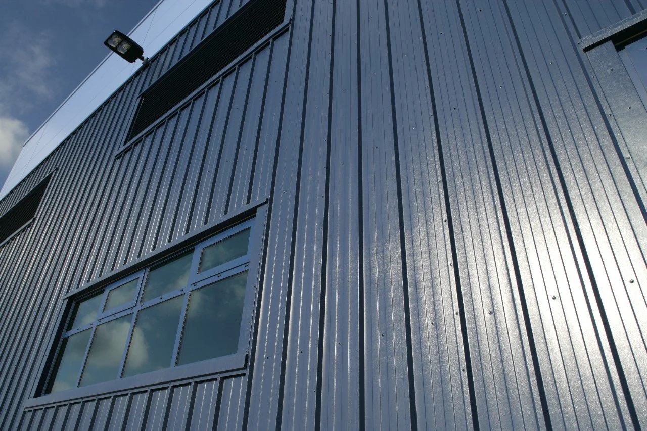 commerica industrial modern building's exterior with vertical metal cladding and rectangular windows