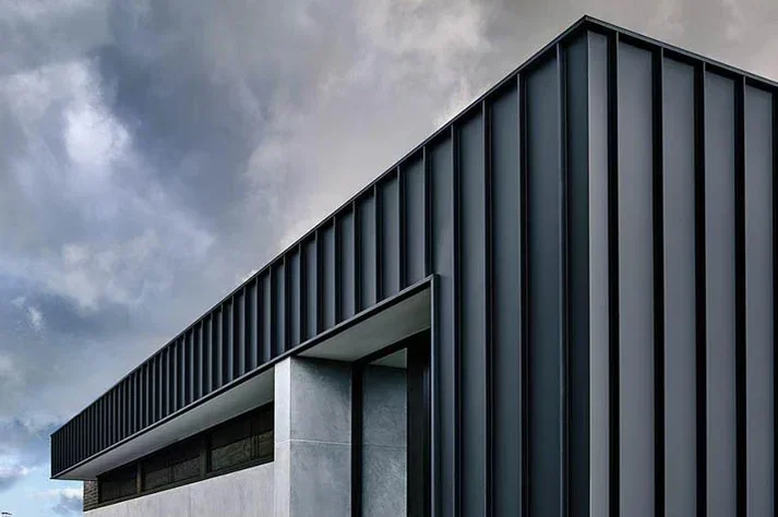 Industrial building's corner with black metal cladding