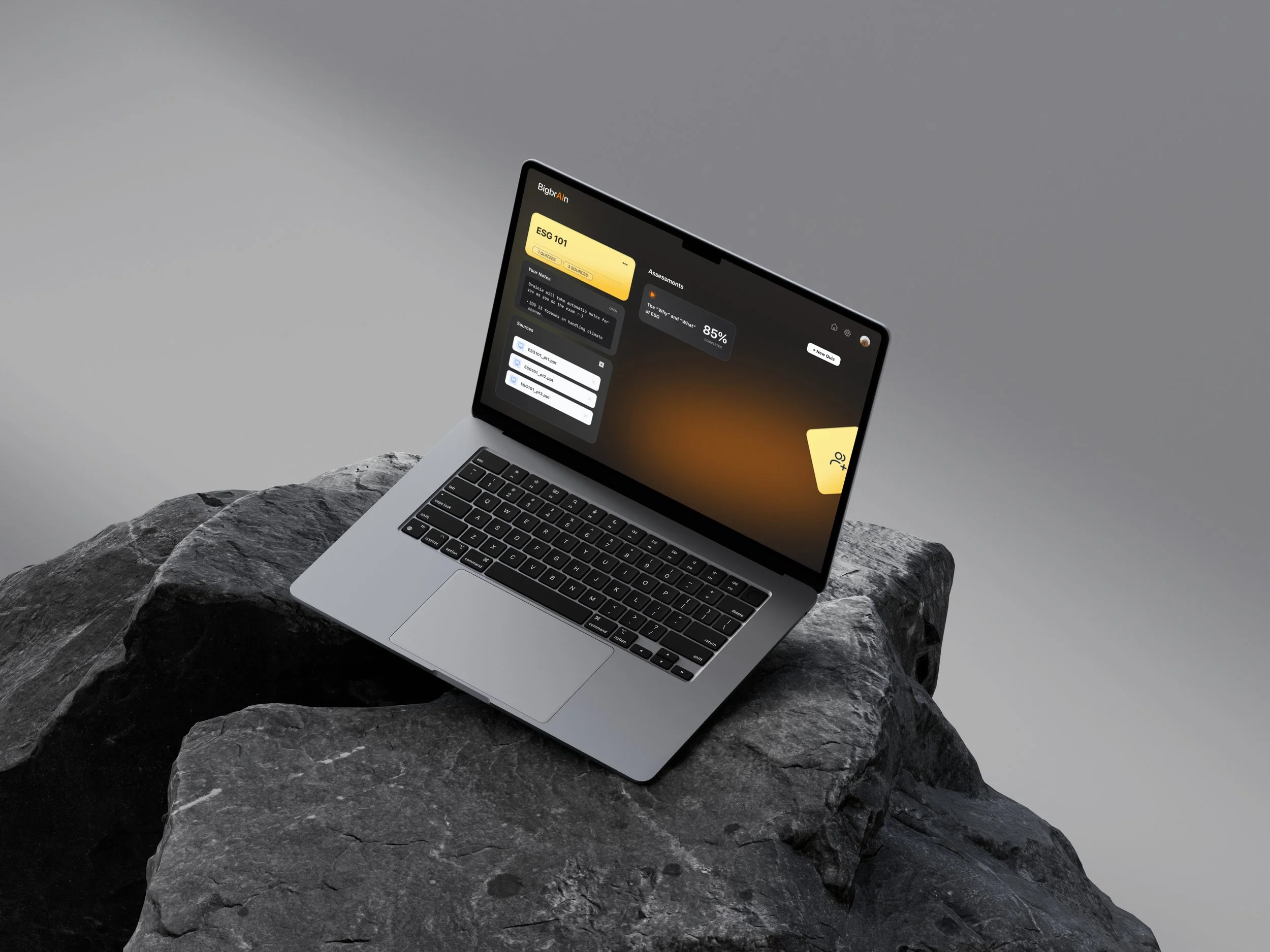 A MacBook Air 15" perched on dark, textured rocks displays a dark-mode UI prototype for the "BigBrAIn" app's Quiz Hub.